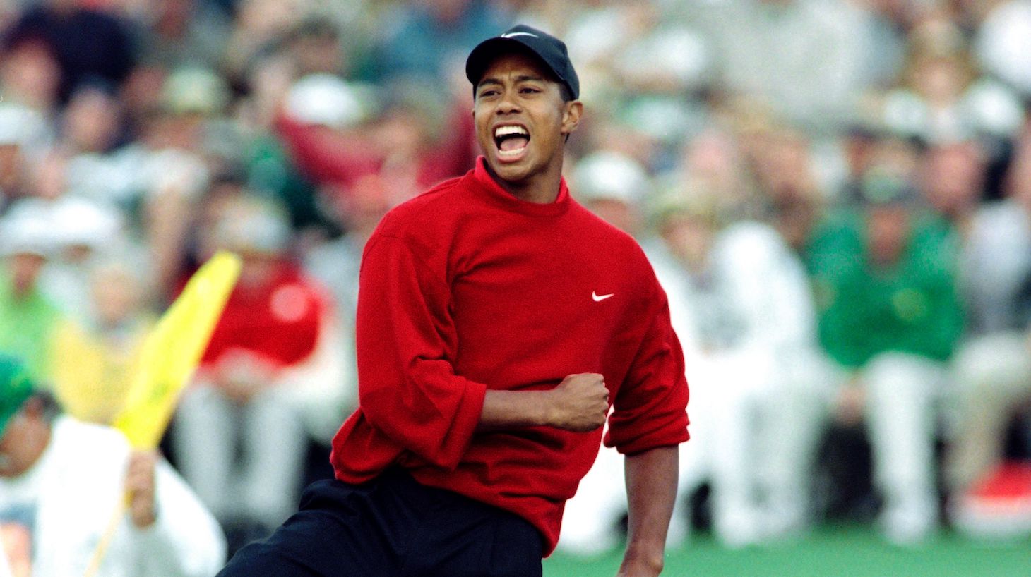 Tiger Woods celebrates on the eighteenth green after winning the 1997 Masters tournament at Augusta National Golf Club in Georgia, on April 13 1997. Woods finished with a record eighteen-under-par. / AFP PHOTO / Timothy A. CLARY (Photo credit should read TIMOTHY A. CLARY/AFP via Getty Images)