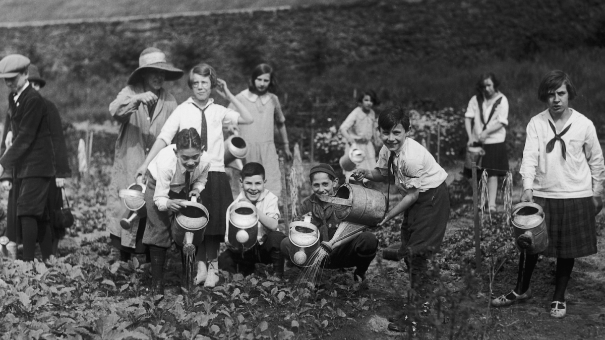 An old-timey photo of some kids gardening in New York City