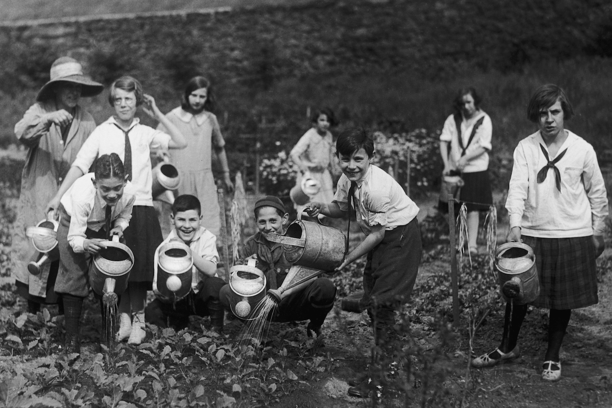 An old-timey photo of some kids gardening in New York City
