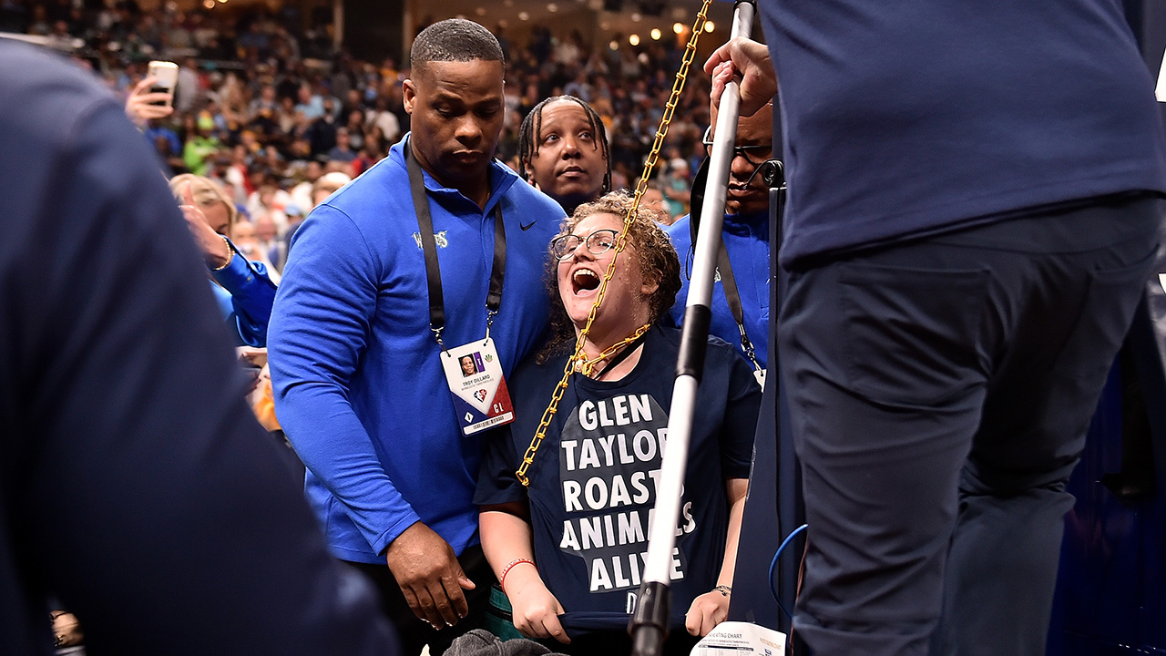 MEMPHIS, TENNESSEE - APRIL 16: A activist chains herself to the goal during the first half of Game One of the Western Conference First Round between the Memphis Grizzlies and the Minnesota Timberwolves on April 16, 2022.