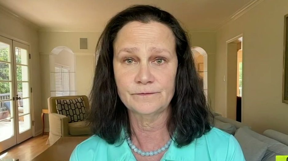 A screencap of tennis player and tennis commentator Pam Shriver. It is from her appearance on Outside the Lines, where she talked about her inappropriate relationship with her coach. She is in what appears to be her home.