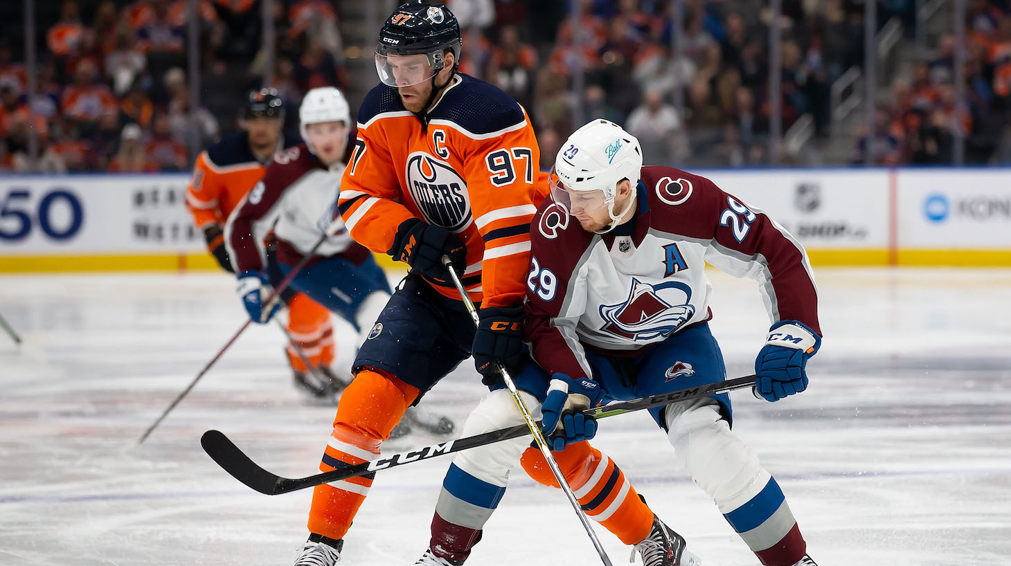 EDMONTON, AB - APRIL 09: Connor McDavid #97 of the Edmonton Oilers battles against Nathan MacKinnon #29 of the Colorado Avalanche during the second period at Rogers Place on April 9, 2022 in Edmonton, Canada. (Photo by Codie McLachlan/Getty Images)