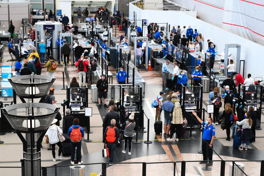 Airline passengers wait at a TSA checkpoint