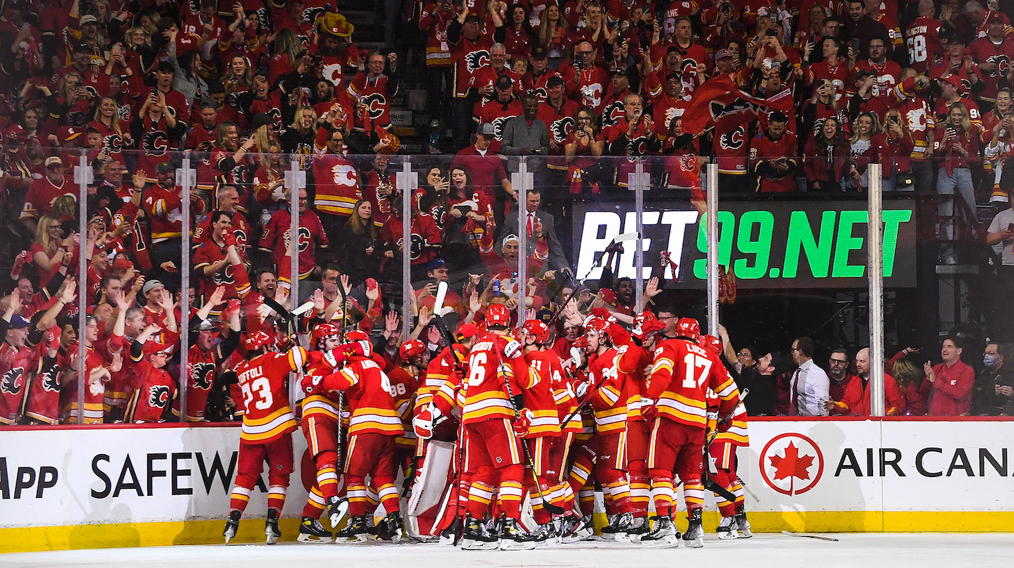 CALGARY, AB - MAY 15: The Calgary Flames celebrate after defeating the Dallas Stars during the overtime period of Game Seven of the First Round of the 2022 Stanley Cup Playoffs at Scotiabank Saddledome on May 15, 2022 in Calgary, Alberta, Canada. The Flames defeated the Stars 3-2 in overtime. (Photo by Derek Leung/Getty Images)