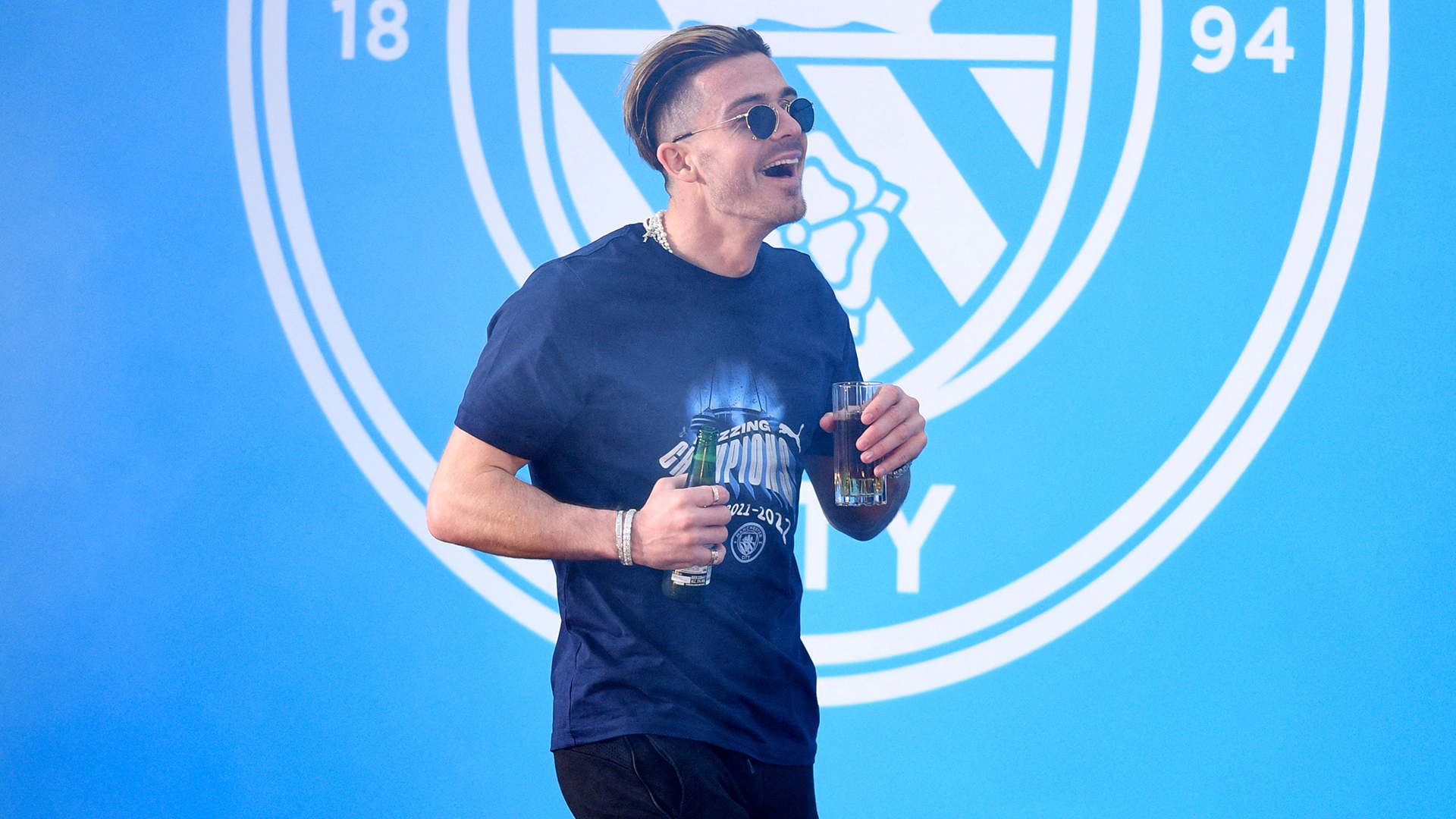 Manchester City's English midfielder Jack Grealish attends an event for fans with members of the Manchester City football team following an open-top bus parade through Manchester, north-west England on May 23, 2022, to celebrate winning the 2021-22 Premier League title.