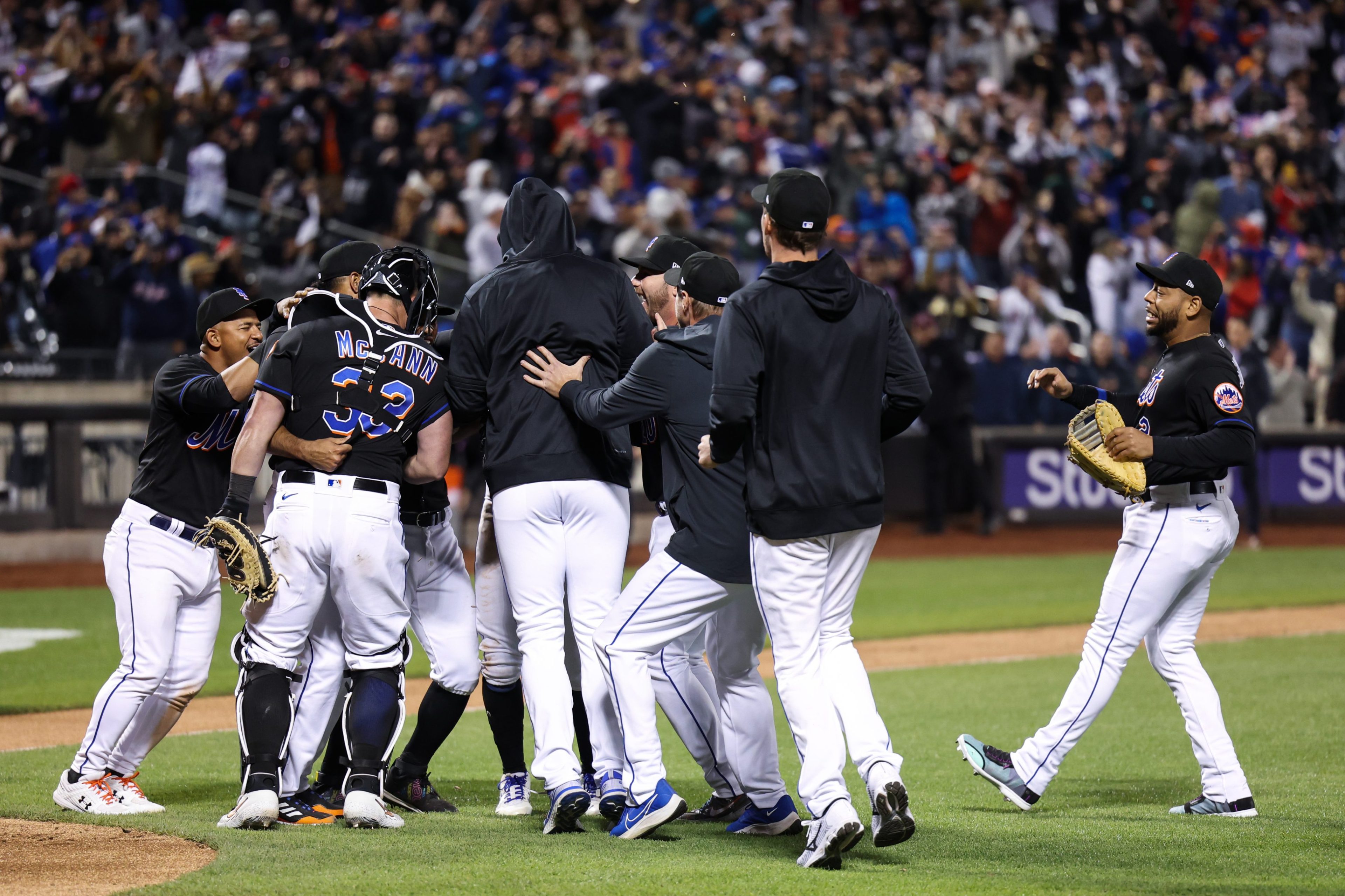 Mets players mobbing closer Edwin Diaz after he got the last out of the team's combined no-hitter against the Phillies.