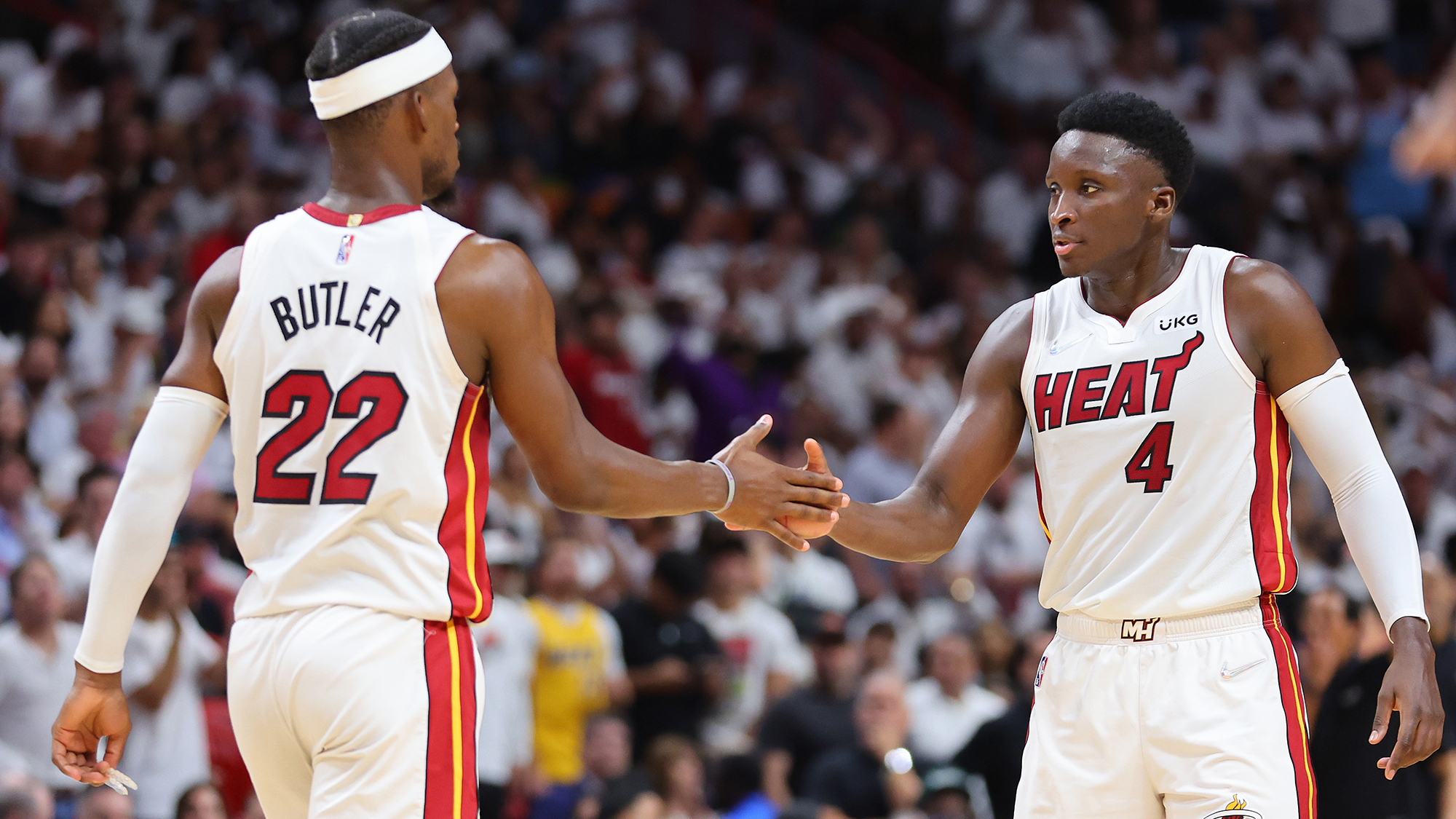 Jimmy Butler #22 and Victor Oladipo #4 of the Miami Heat high five against the Philadelphia 76ers during the second half in Game Two of the Eastern Conference Semifinals at FTX Arena on May 04, 2022 in Miami, Florida.