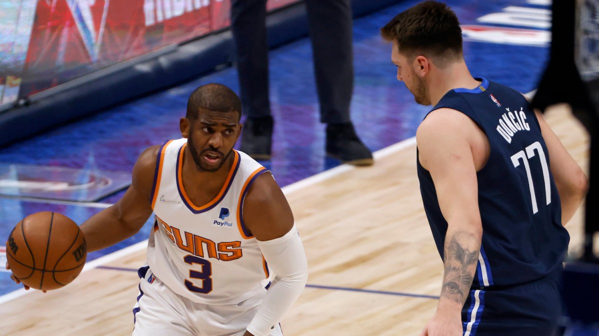 DALLAS, TEXAS - MAY 12: Chris Paul #3 of the Phoenix Suns dribbles the ball against Luka Doncic #77 of the Dallas Mavericks in the first quarter of Game Six of the 2022 NBA Playoffs Western Conference Semifinals at American Airlines Center on May 12, 2022 in Dallas, Texas. NOTE TO USER: User expressly acknowledges and agrees that, by downloading and/or using this photograph, User is consenting to the terms and conditions of the Getty Images License Agreement. (Photo by Ron Jenkins/Getty Images)