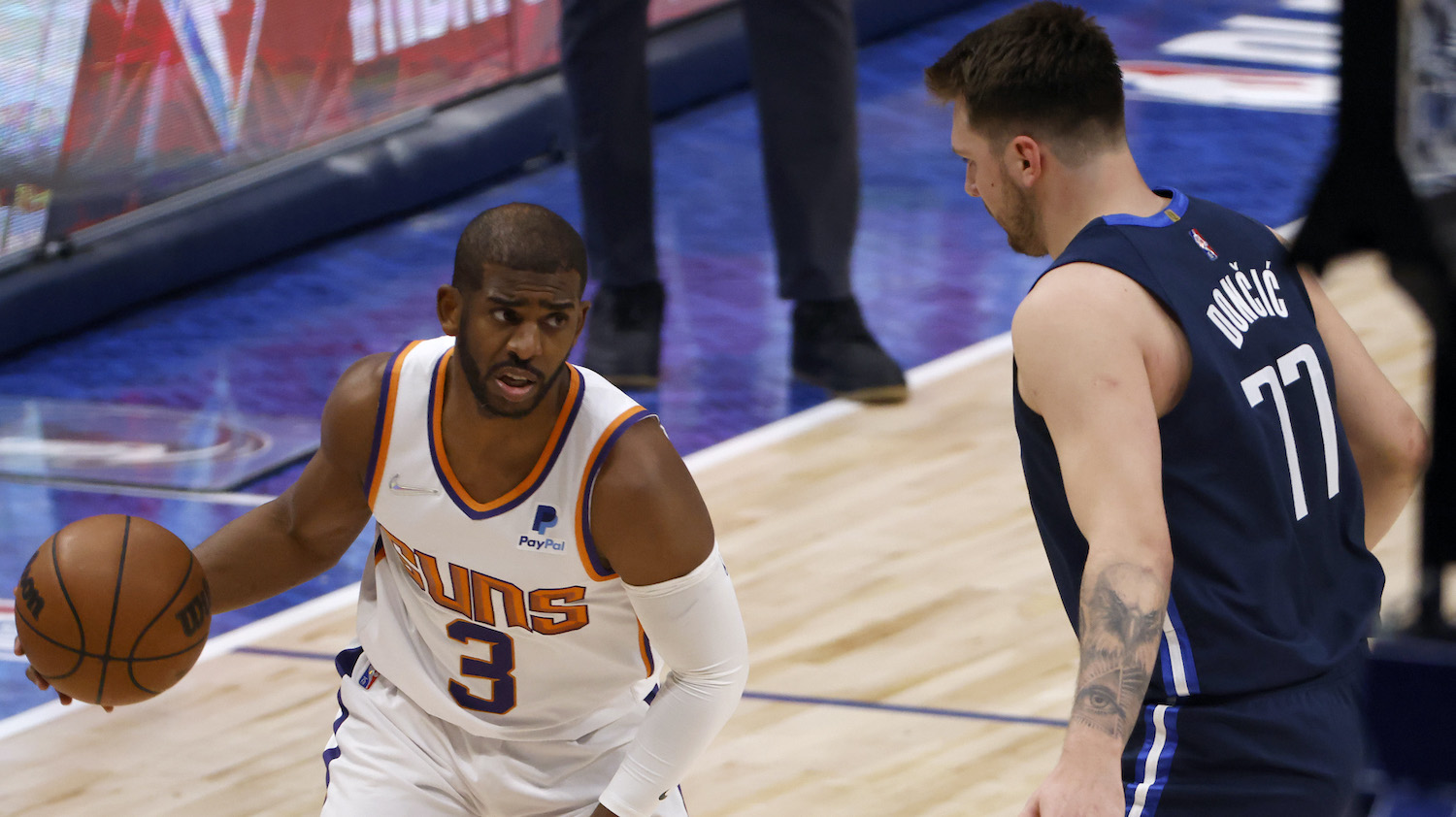 DALLAS, TEXAS - MAY 12: Chris Paul #3 of the Phoenix Suns dribbles the ball against Luka Doncic #77 of the Dallas Mavericks in the first quarter of Game Six of the 2022 NBA Playoffs Western Conference Semifinals at American Airlines Center on May 12, 2022 in Dallas, Texas. NOTE TO USER: User expressly acknowledges and agrees that, by downloading and/or using this photograph, User is consenting to the terms and conditions of the Getty Images License Agreement. (Photo by Ron Jenkins/Getty Images)