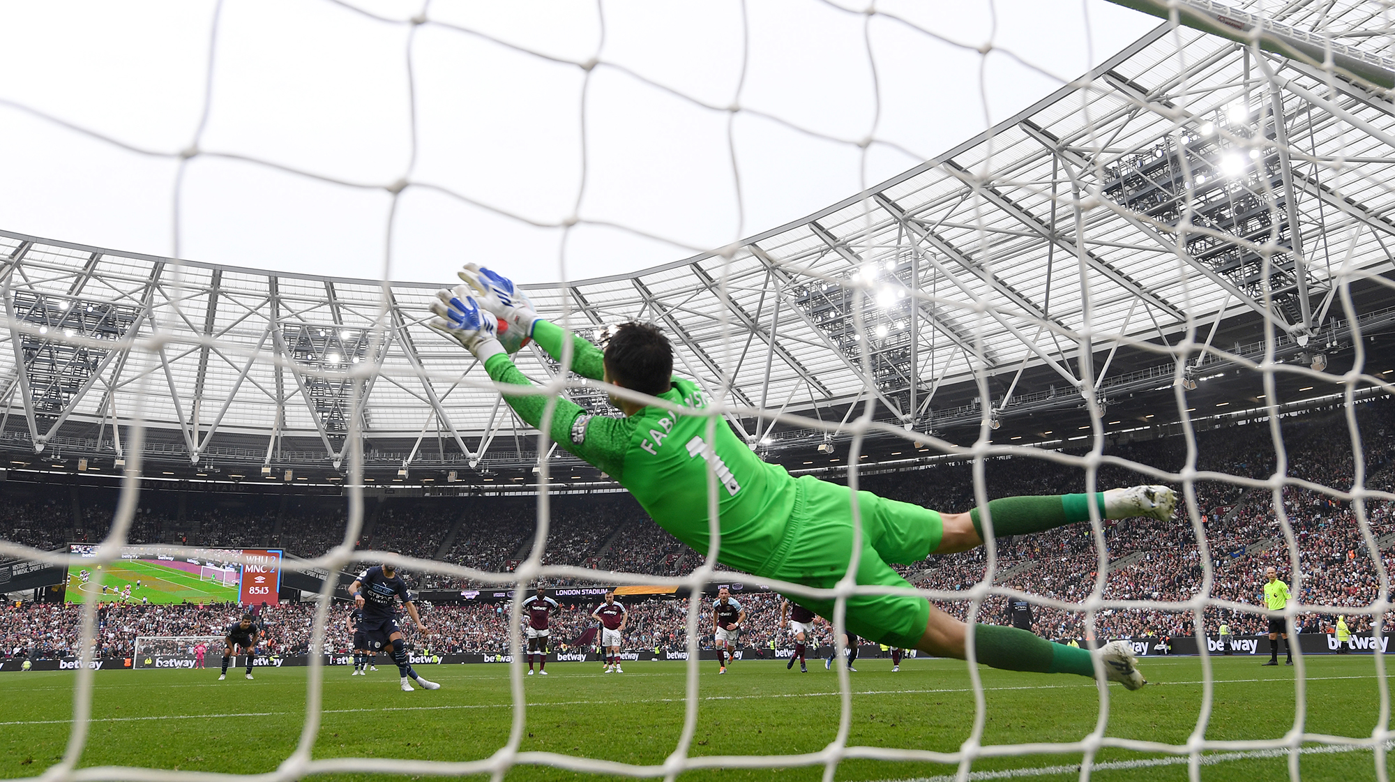 Lukasz Fabianski of West Ham United saves a penalty from Riyad Mahrez of Manchester City during the Premier League match between West Ham United and Manchester City at London Stadium on May 15, 2022 in London, England