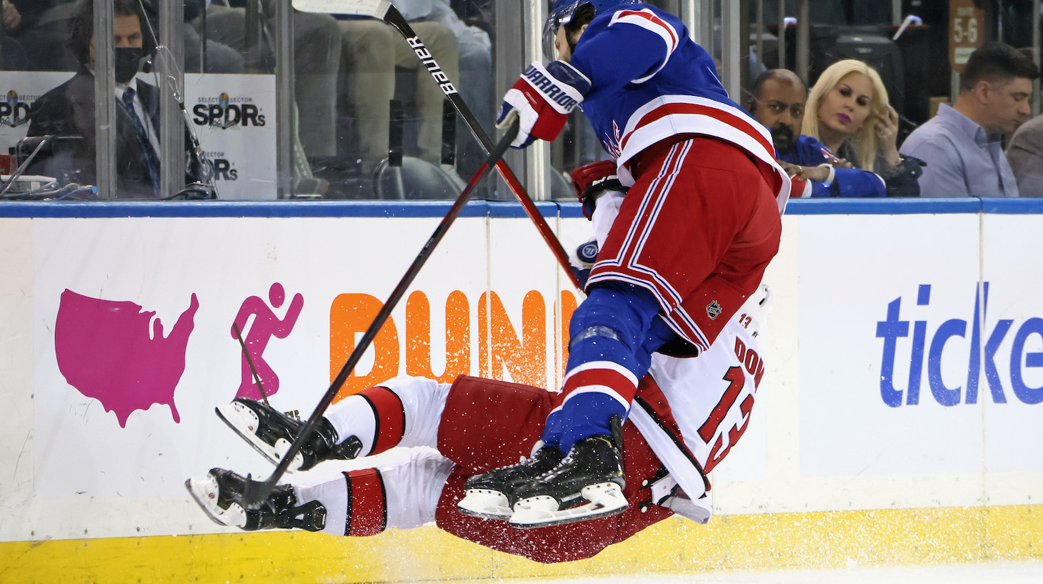 NEW YORK, NEW YORK - MAY 24: Max Domi #13 of the Carolina Hurricanes is checked by Jacob Trouba #8 of the New York Rangers during the first period in Game Four of the Second Round of the 2022 Stanley Cup Playoffs at Madison Square Garden on May 24, 2022 in New York City. (Photo by Bruce Bennett/Getty Images)