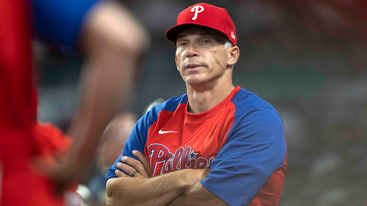 Joe Girardi in a red and blue Phillies warm-up top
