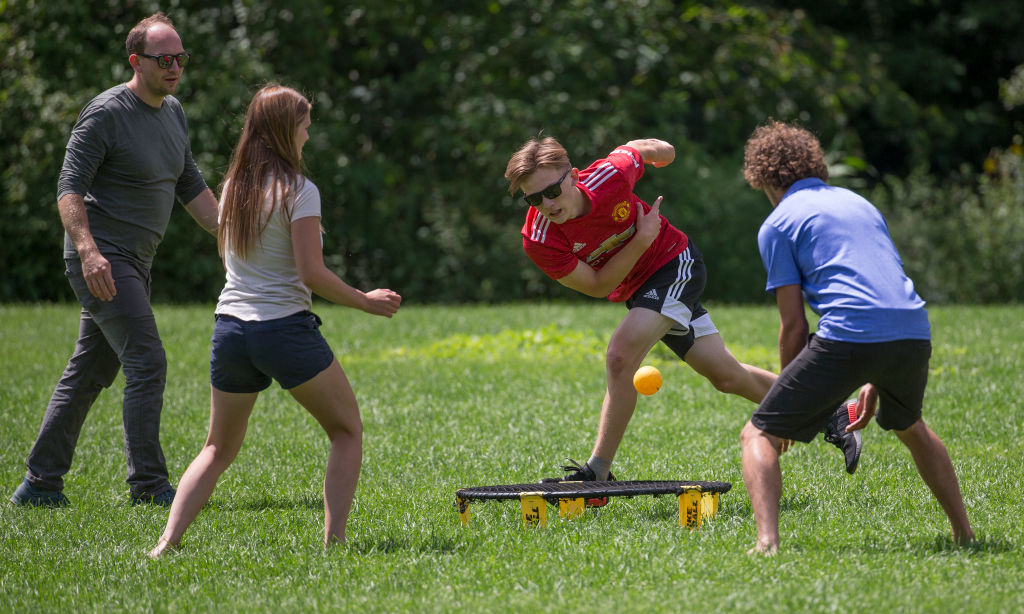 TORONTO, ON - AUGUST 5: Caedmon Dunbar (red shirt) plays the ball during a game of Spike Ball in High Park. Josh DeGrott (blue shirt) waits to react to the hit as Robbie Dunbar (left) and Naomi DeGrott keep an eye on play. Feature pictures from around Toronto. COVID-19. CORONAPD Toronto Star/Rick Madonik