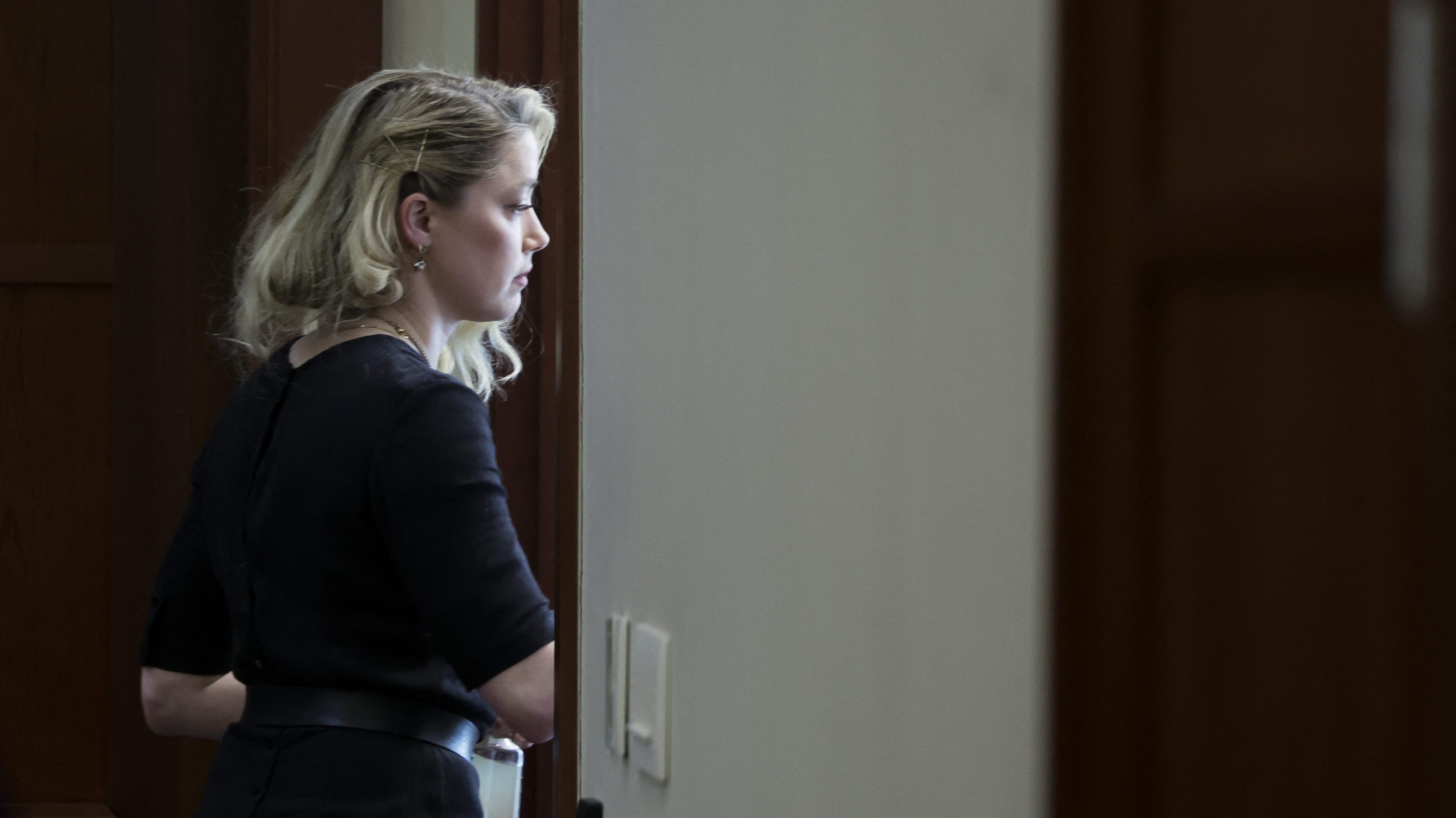 Amber Heard leaves after the jury announced a split verdict in favor of both Johnny Depp and Amber Heard on their claim and counter-claim in the Depp v. Heard civil defamation trial at the Fairfax County Circuit Courthouse in Fairfax, Virginia, on June 1, 2022.