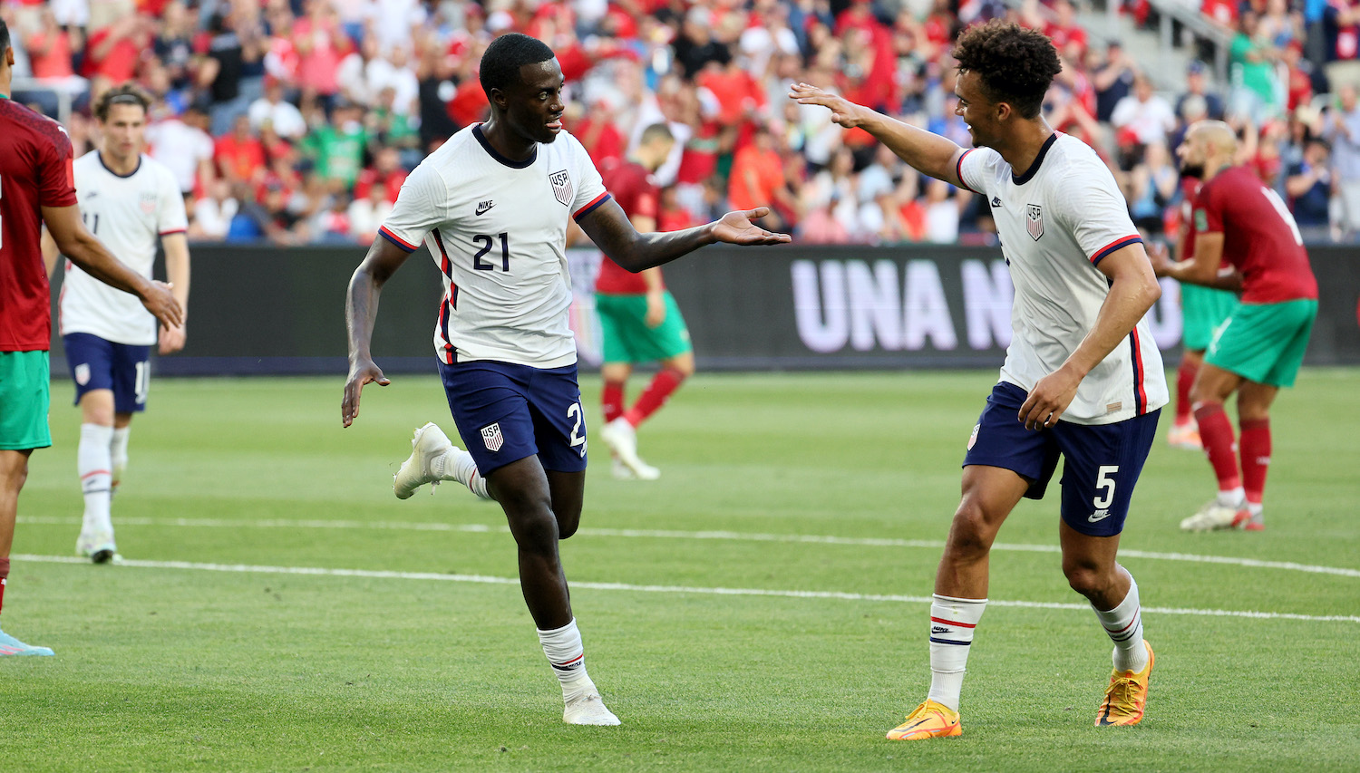 CINCINNATI, OHIO - JUNE 01: Tim Weah #21of the United States celebrates with Antonee Robinson #5 after scoring a first half goal against Morocco at TQL Stadium on June 01, 2022 in Cincinnati, Ohio. (Photo by Andy Lyons/Getty Images)