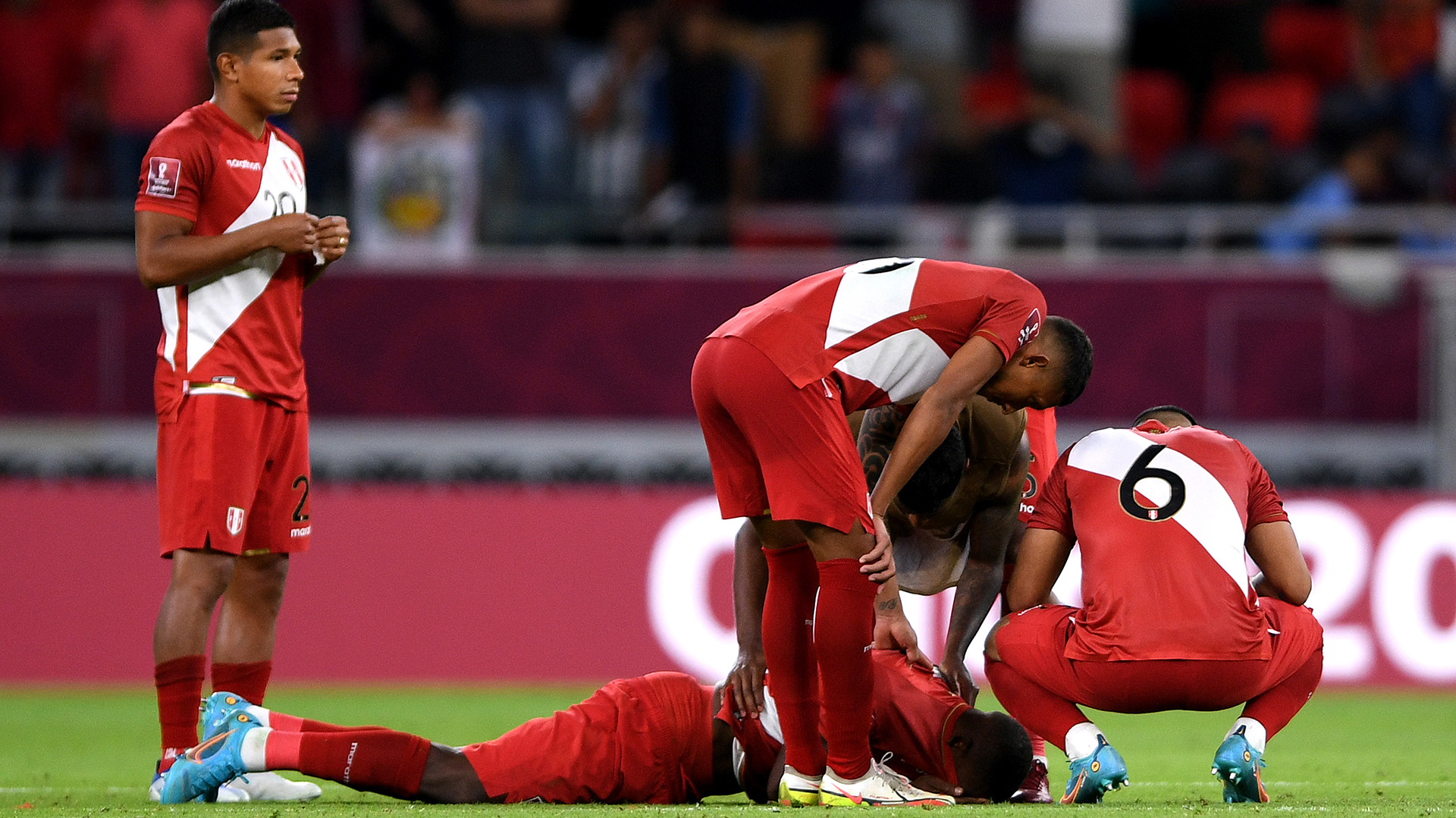 Dejected Peru players support each other after being defeated by Australia in the 2022 FIFA World Cup Playoff match between Australia Socceroos and Peru at Ahmad Bin Ali Stadium on June 13, 2022 in Doha, Qatar.
