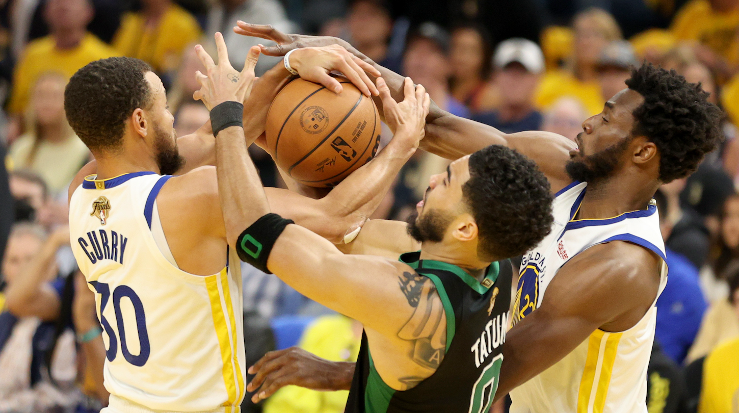 Stephen Curry and Andrew Wiggins (Golden State Warriors) wrestle Jayson Tatum (Boston Celtics) for the ball