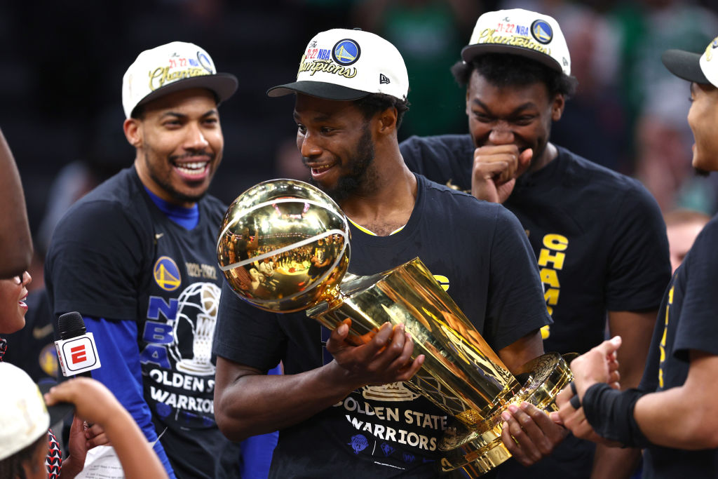 Andrew Wiggins cradles the Larry O'Brien trophy.