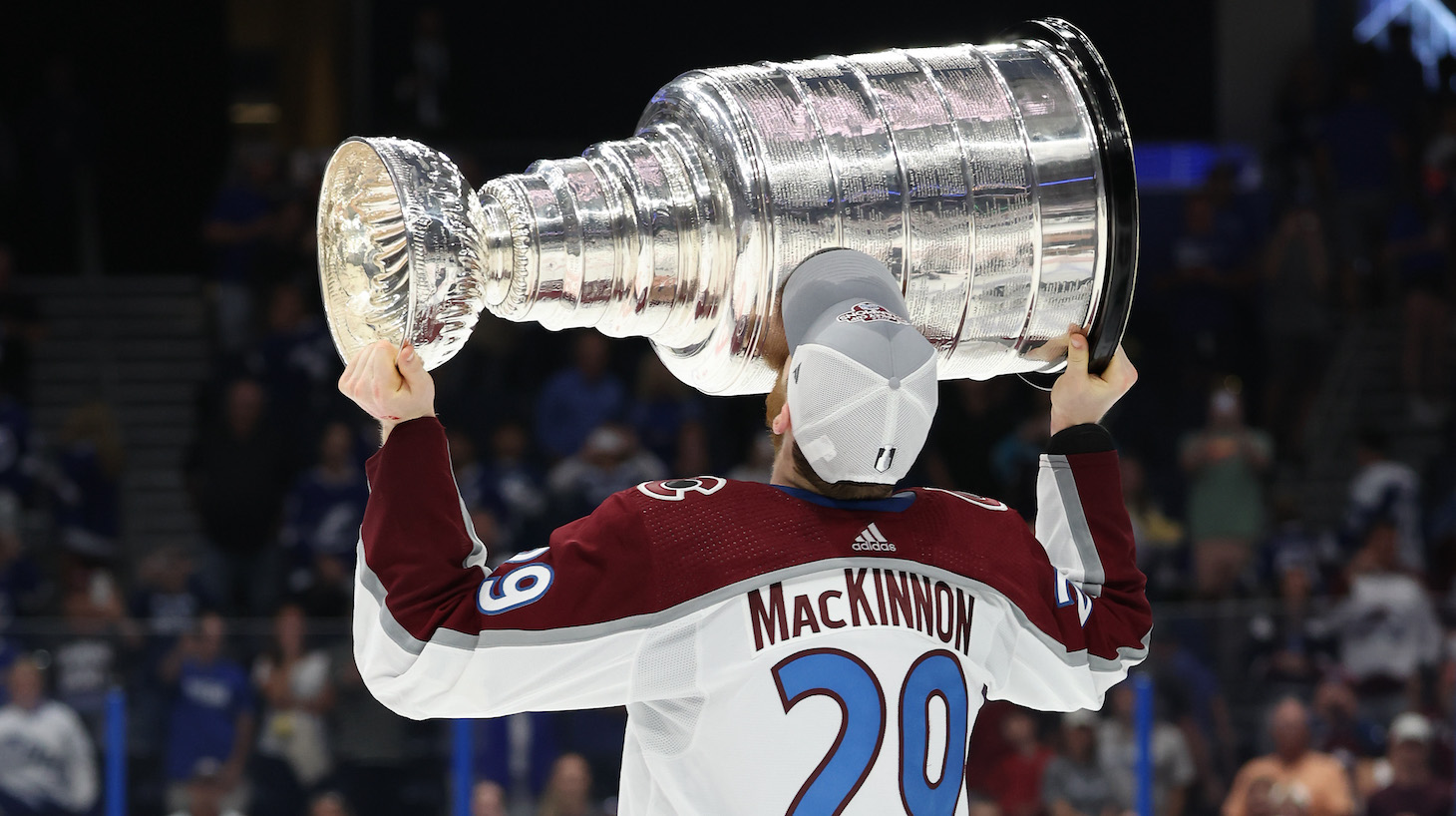 TAMPA, FLORIDA - JUNE 26: Nathan MacKinnon #29 of the Colorado Avalanche lifts the Stanley Cup after defeating the Tampa Bay Lightning 2-1 in Game Six of the 2022 NHL Stanley Cup Final at Amalie Arena on June 26, 2022 in Tampa, Florida. (Photo by Christian Petersen/Getty Images)