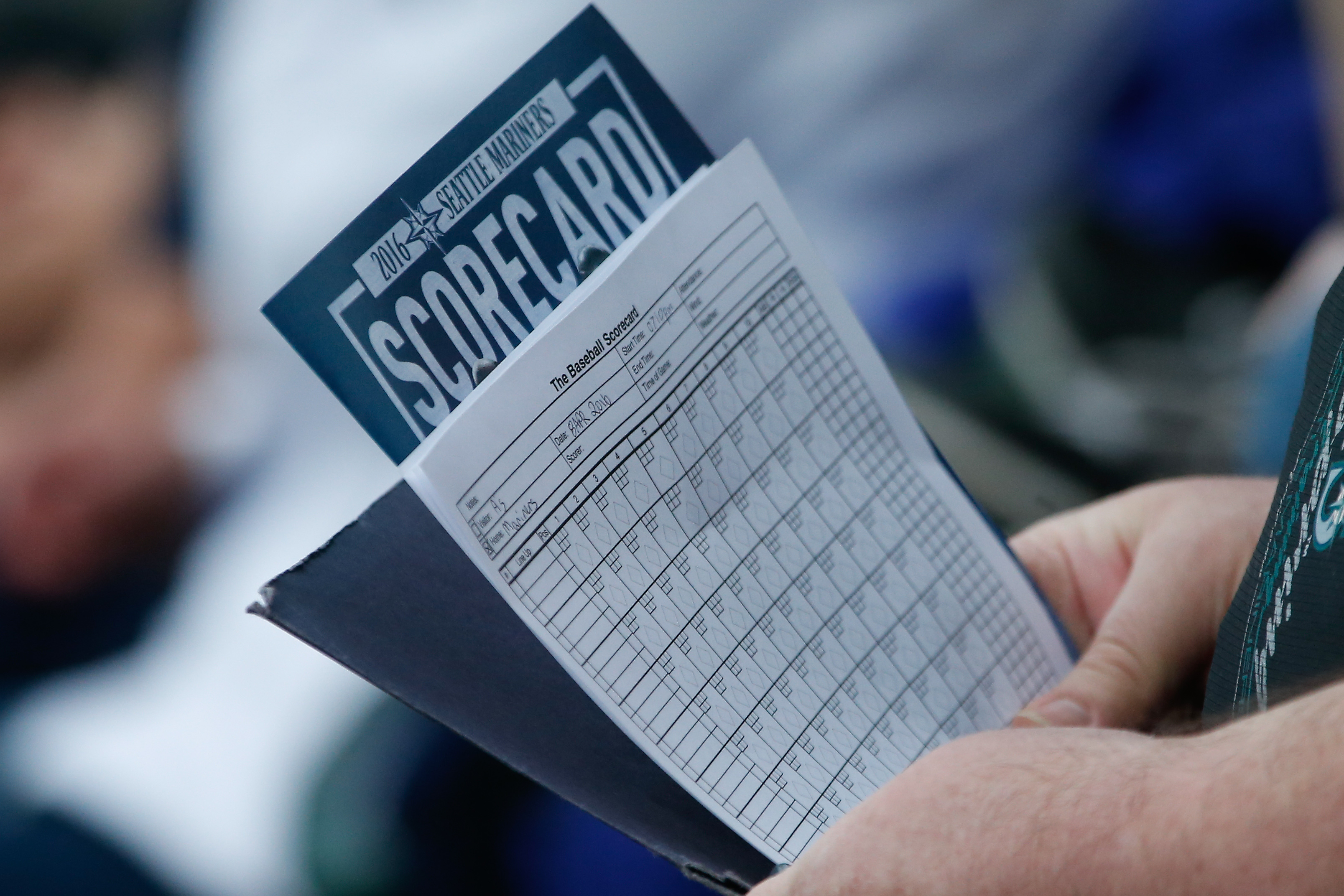 A fan holds a scorecard