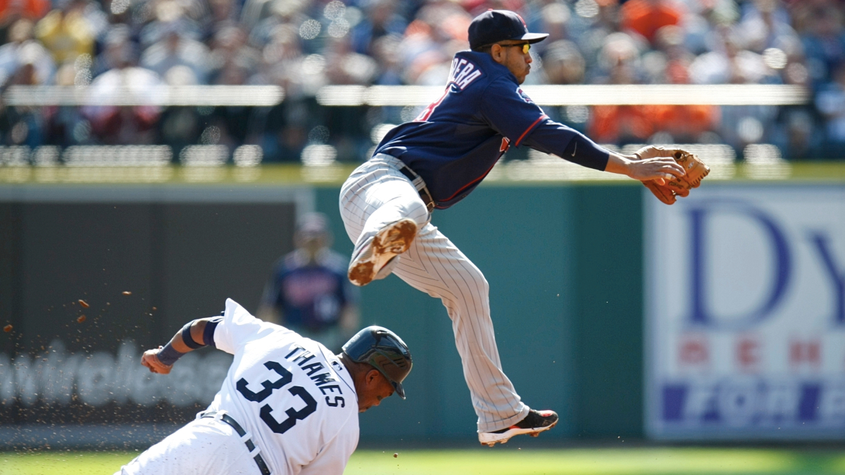 Orlando Cabrera throws the ball to try and turn a double play as Marcus Thames slides