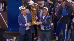 Warriors owners Joe Lacob and Peter Guber, with the Larry O'Brien NBA championship trophy