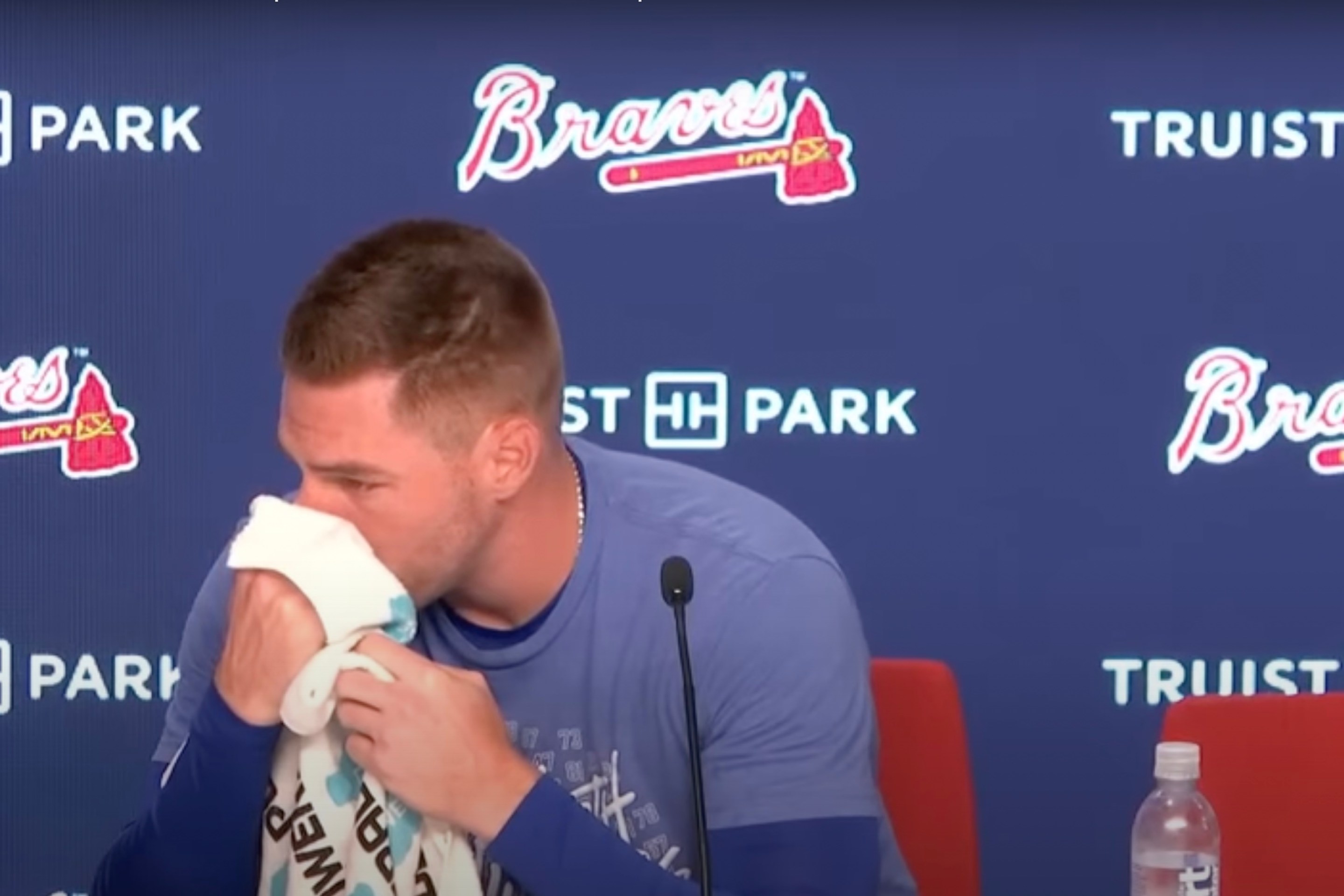 An emotional Freddie Freeman wipes his nose with a towel during a presser.