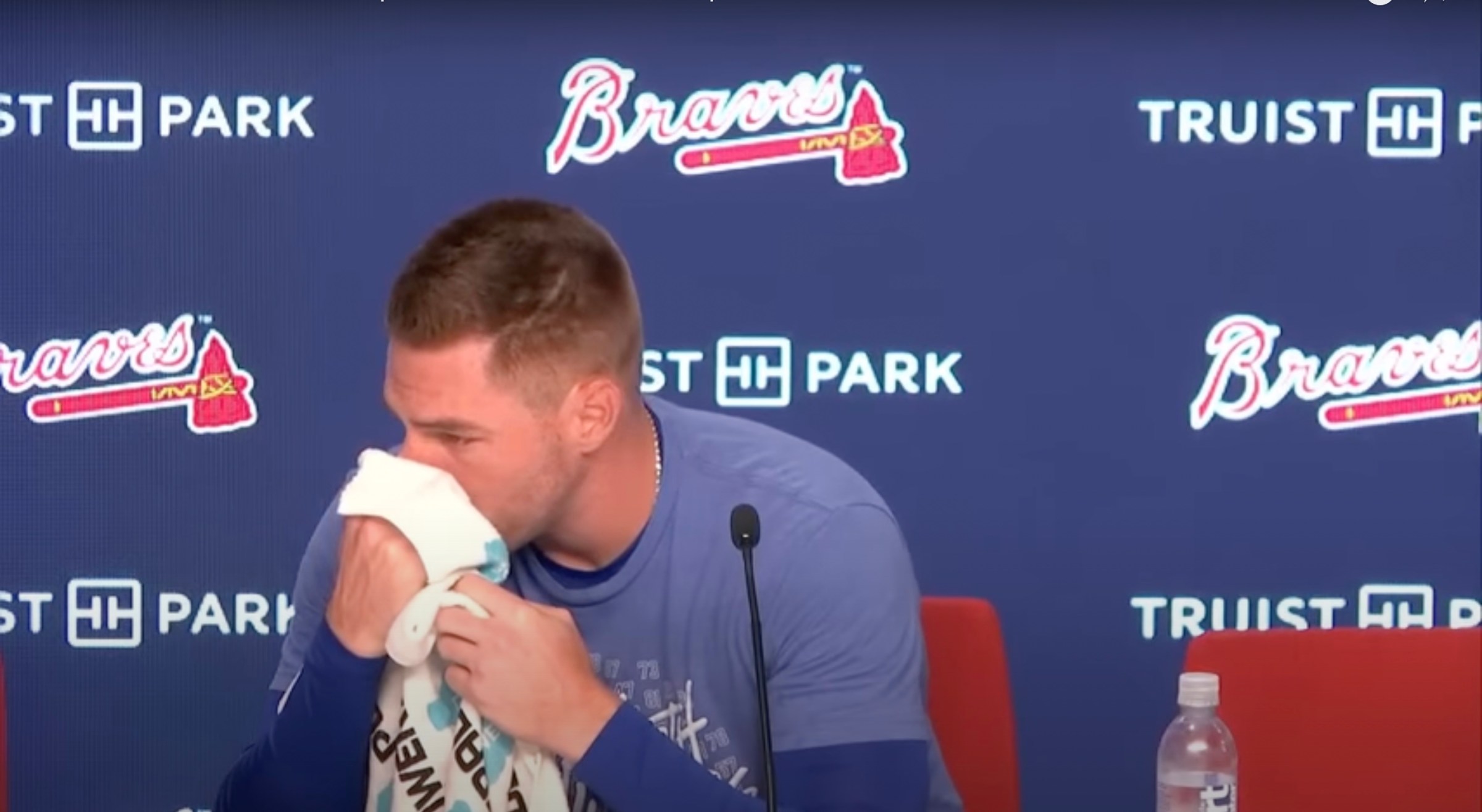 An emotional Freddie Freeman wipes his nose with a towel during a presser.