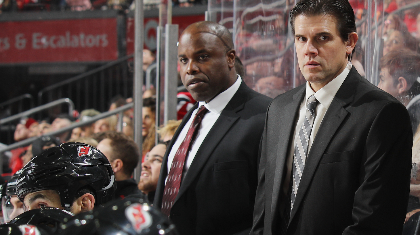 NEWARK, NEW JERSEY - OCTOBER 18: (l-r) Mike Grier, Rick Kowalsky and John Hynes of the New Jersey Devils work the game against the Colorado Avalanche at the Prudential Center on October 18, 2018 in Newark, New Jersey. The Avalanche defeated the Devils 5-3. (Photo by Bruce Bennett/Getty Images)