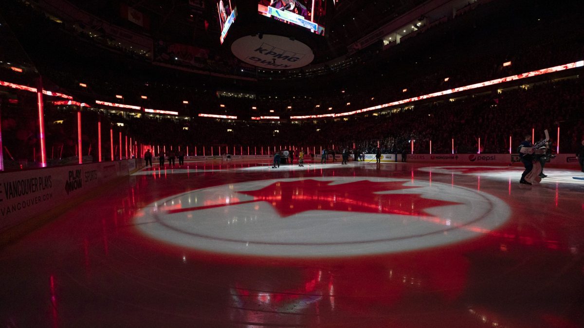 A maple leaf projected onto ice during the Canadian National Anthem
