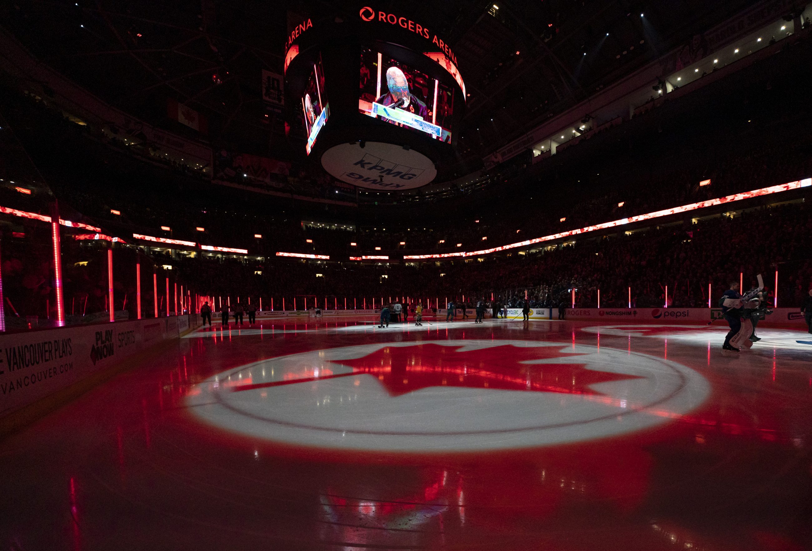 A maple leaf projected onto ice during the Canadian National Anthem