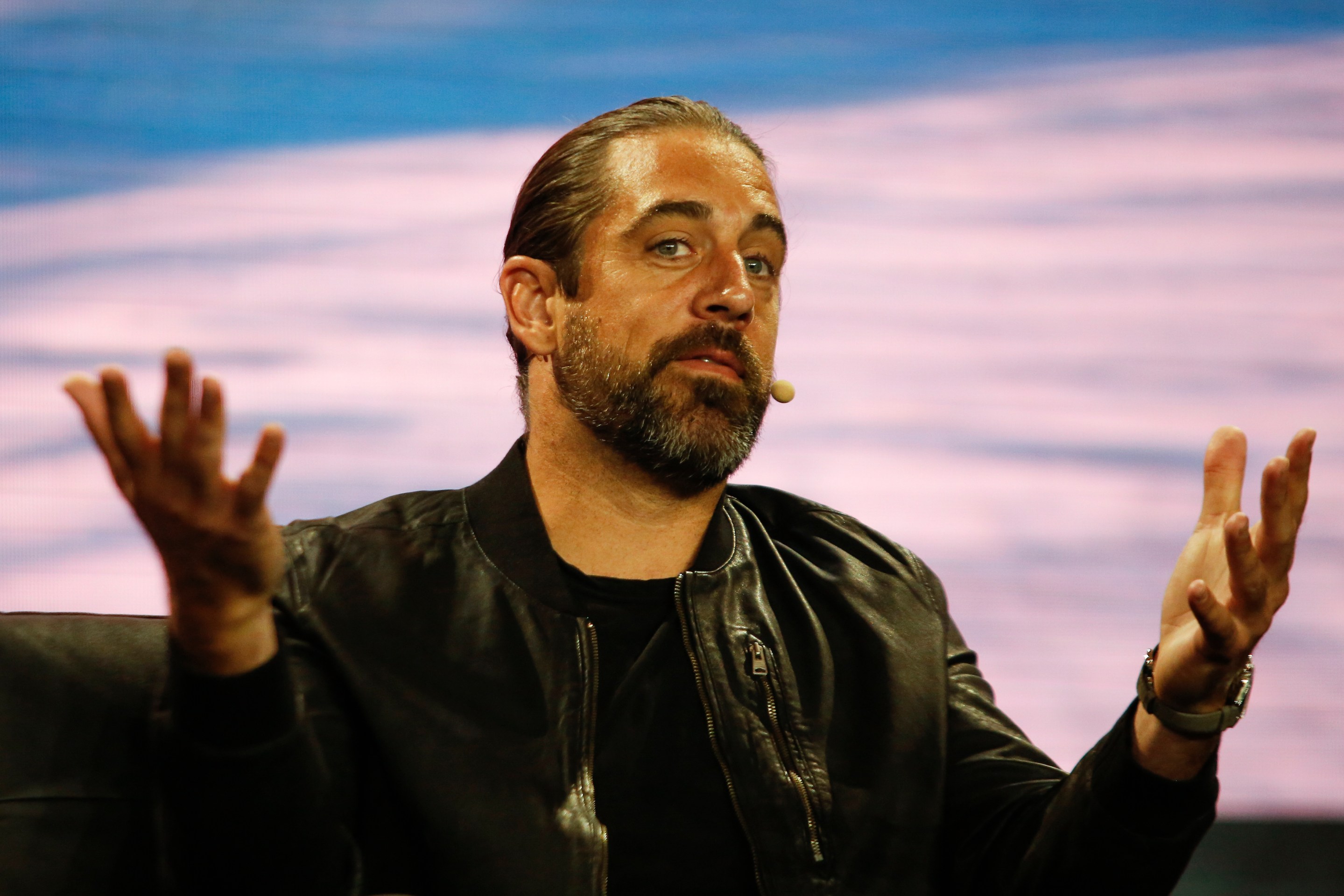 Aaron Rodgers at the Bitcoin 2022 Conference, looking like someone who would be onstage at that conference.