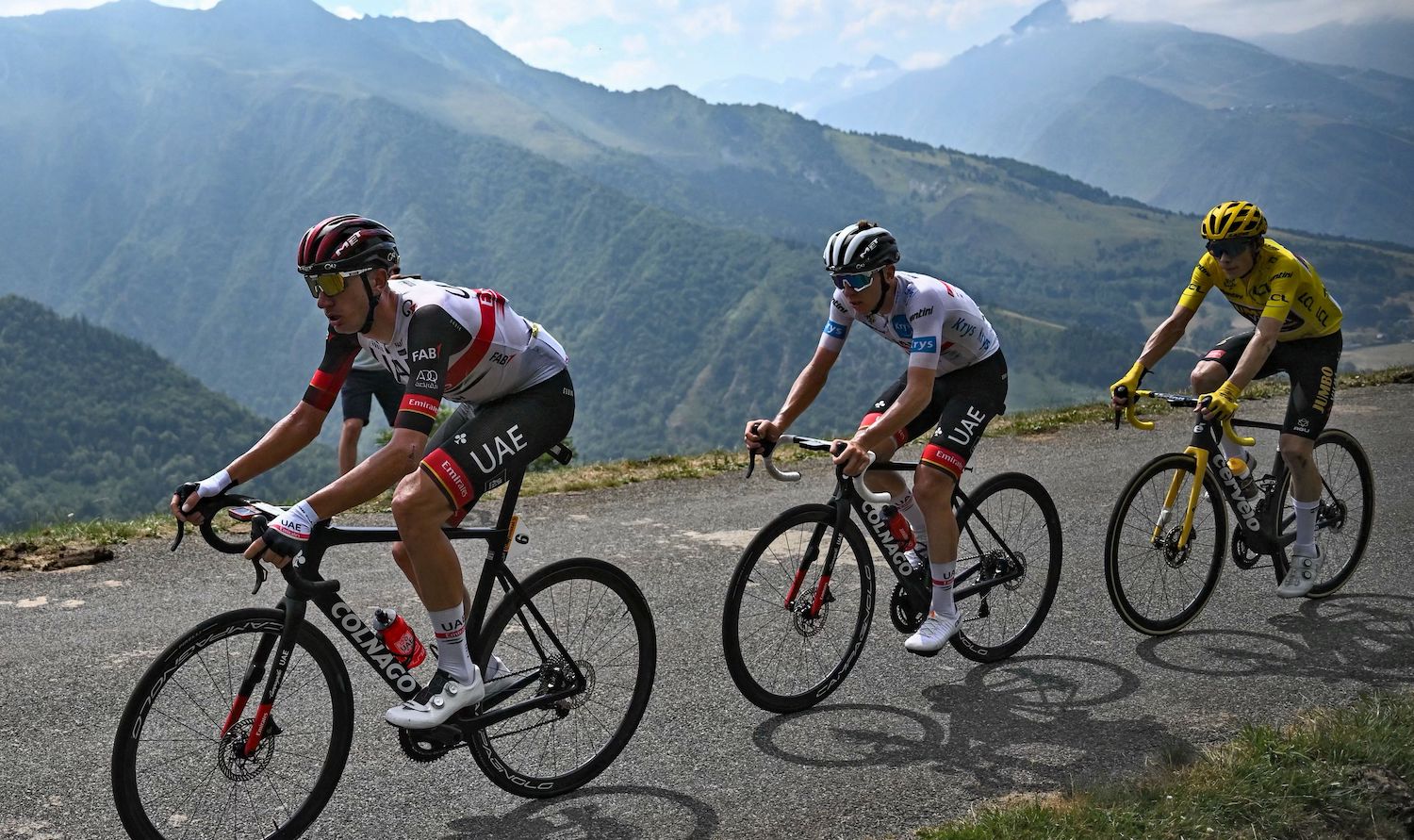 UAE Team Emirates team's American rider Brandon McNulty (L), UAE Team Emirates team's Slovenian rider Tadej Pogacar (C) wearing the best young rider's white jersey, and Jumbo-Visma team's Danish rider Jonas Vingegaard (R) wearing the overall leader's yellow jersey cycle in the ascent of Peyragudes during the 17th stage of the 109th edition of the Tour de France cycling race, 129,7 km between Saint-Gaudens and Peyragudes, in southwestern France, on July 20, 2022. (Photo by Anne-Christine POUJOULAT / AFP) (Photo by ANNE-CHRISTINE POUJOULAT/AFP via Getty Images)