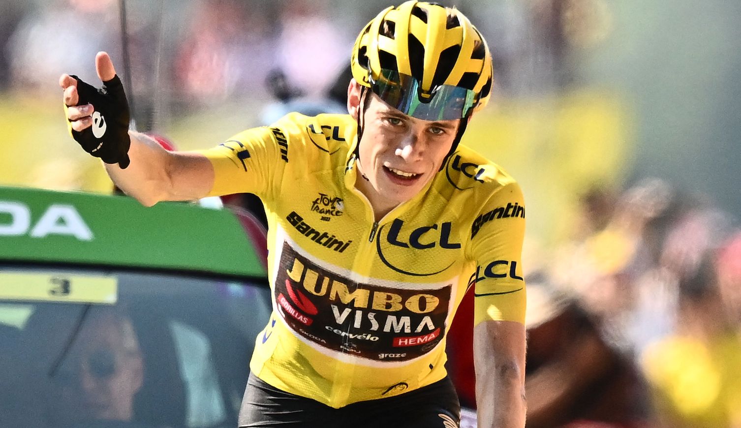 TOPSHOT - Jumbo-Visma team's Danish rider Jonas Vingegaard wearing the overall leader's yellow jersey celebrates as he cycles to the finish line to win the 18th stage of the 109th edition of the Tour de France cycling race, 143,2 km between Lourdes and Hautacam in the Pyrenees mountains in southwestern France, on July 21, 2022. (Photo by Marco BERTORELLO / AFP) (Photo by MARCO BERTORELLO/AFP via Getty Images)