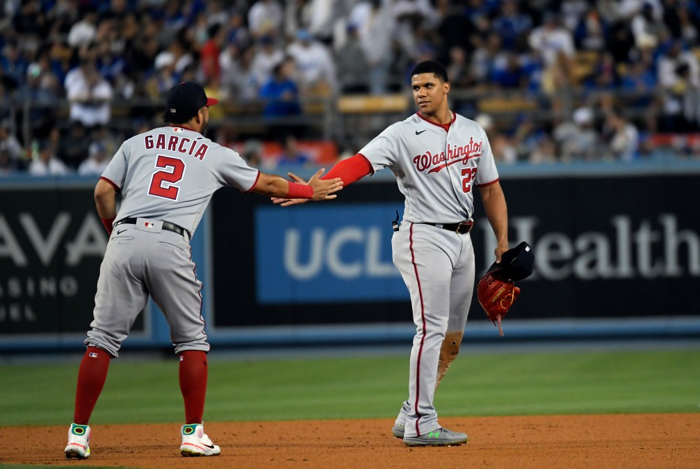 Juan Soto is congratulated by Luis Garcia after hitting a triple