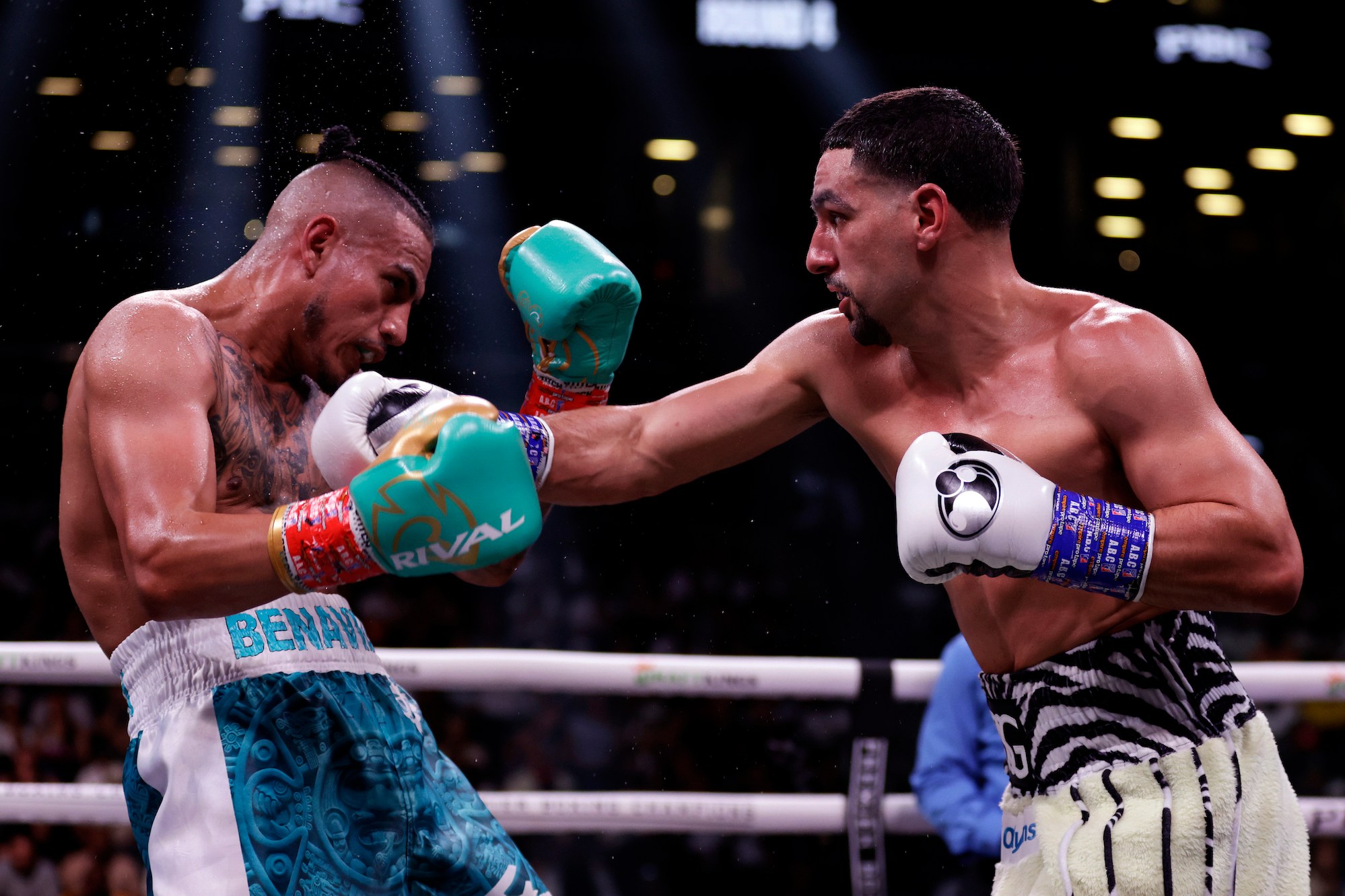 NEW YORK, NEW YORK - JULY 30: Danny Garcia lands a punch on Jose Benavidez Jr. (teal shorts) during their super welterweight boxing match at Barclays Center on July 30, 2022 in in the Brooklyn borough of New York. (Photo by Adam Hunger/Getty Images)