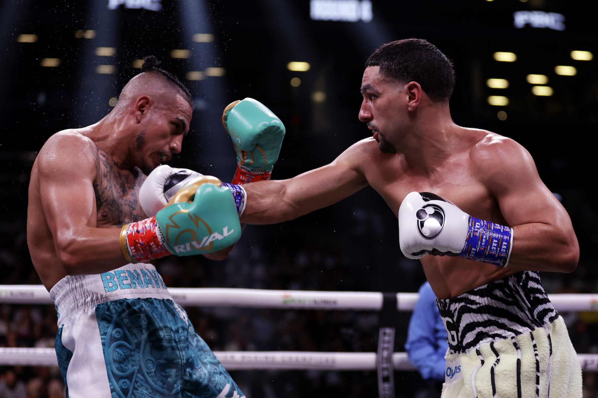 NEW YORK, NEW YORK - JULY 30: Danny Garcia lands a punch on Jose Benavidez Jr. (teal shorts) during their super welterweight boxing match at Barclays Center on July 30, 2022 in in the Brooklyn borough of New York. (Photo by Adam Hunger/Getty Images)