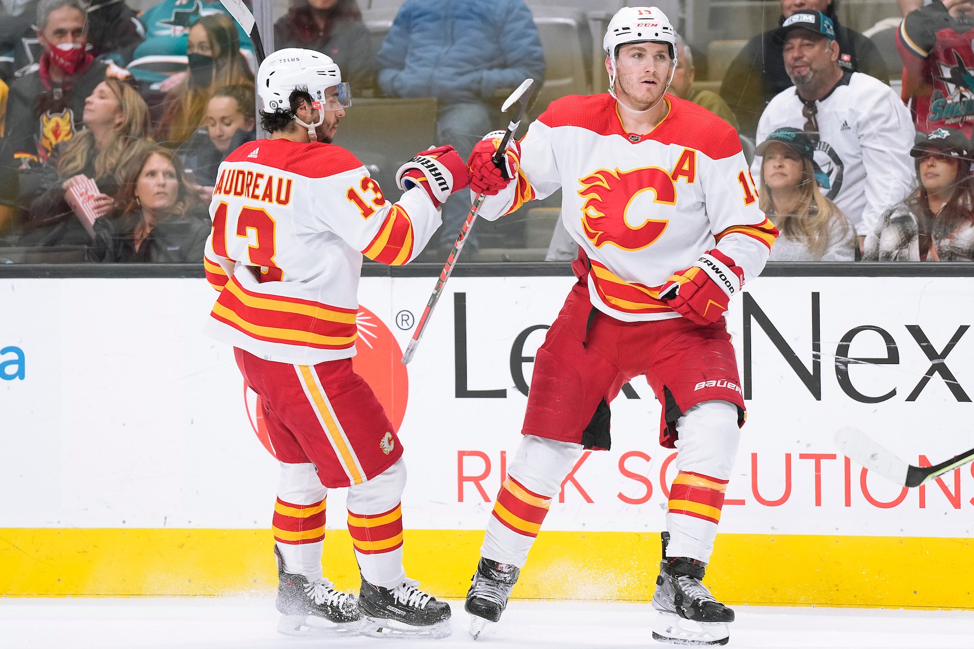 SAN JOSE, CALIFORNIA - APRIL 07: Matthew Tkachuk #19 of the Calgary Flames is congratulated by Johnny Gaudreau #13 after scoring a goal against the San Jose Sharks during the first period of an NHL hockey game at SAP Center on April 07, 2022 in San Jose, California. (Photo by Thearon W. Henderson/Getty Images)