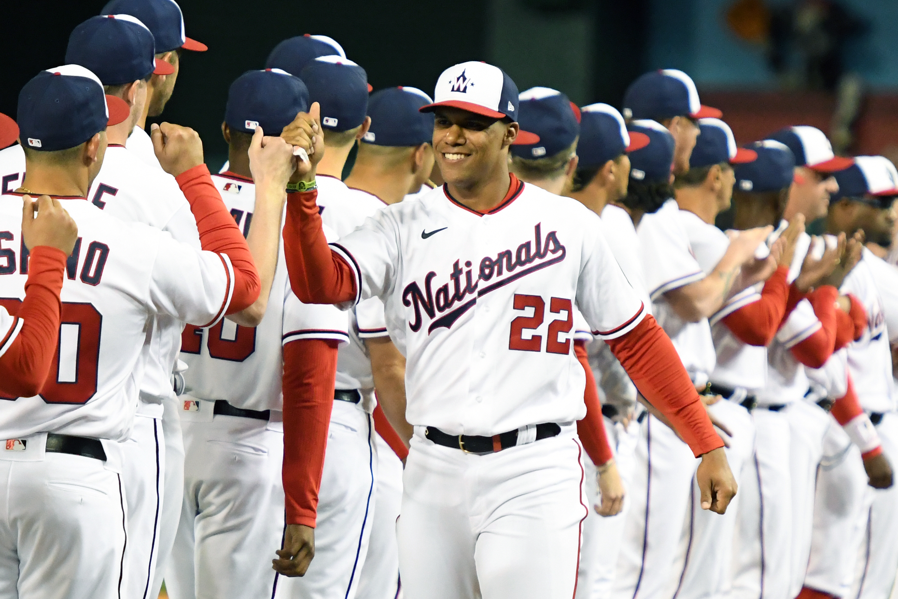 Juan Soto greets his Nationals teammates with a smile on Opening Day, 2022.