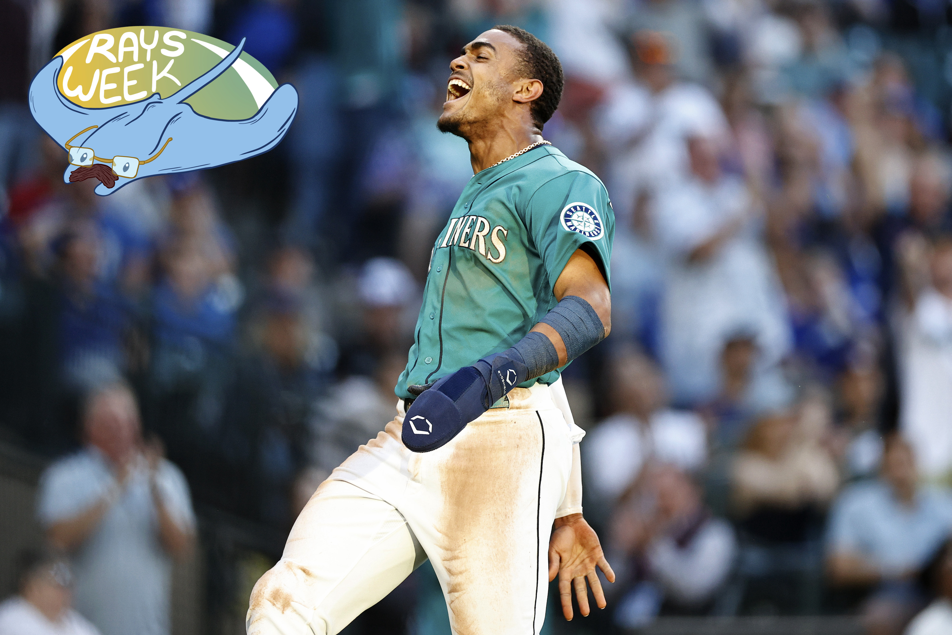 Julio Rodriguez of the Mariners exulting after a win, near the Rays Week badge.
