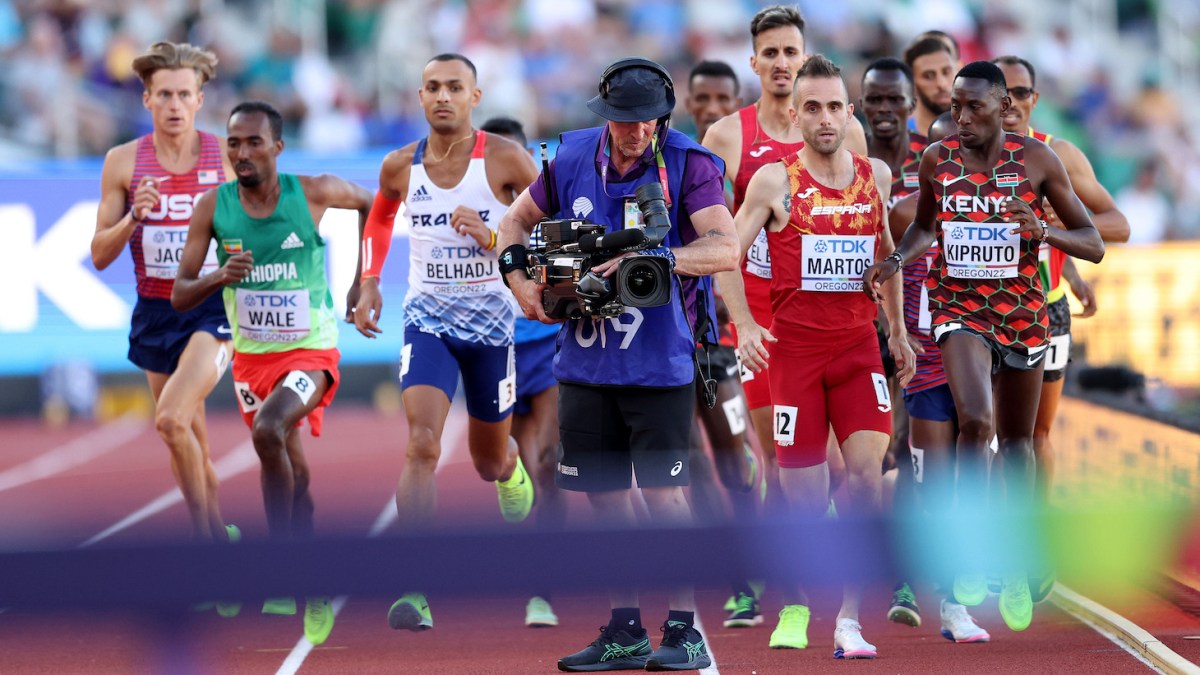 EUGENE, OREGON - JULY 18: Athletes in the Men's 3000m Steeplechase Final run around a cameraman on the track on day four of the World Athletics Championships Oregon22 at Hayward Field on July 18, 2022 in Eugene, Oregon. (Photo by Patrick Smith/Getty Images)