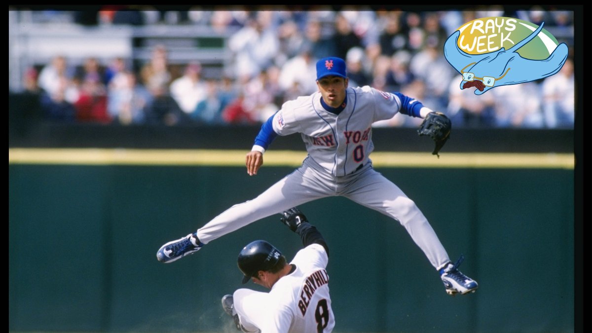 Mets shortstop Rey Ordonez leaps over a sliding Damon Berryhill in a 1997 MLB game.