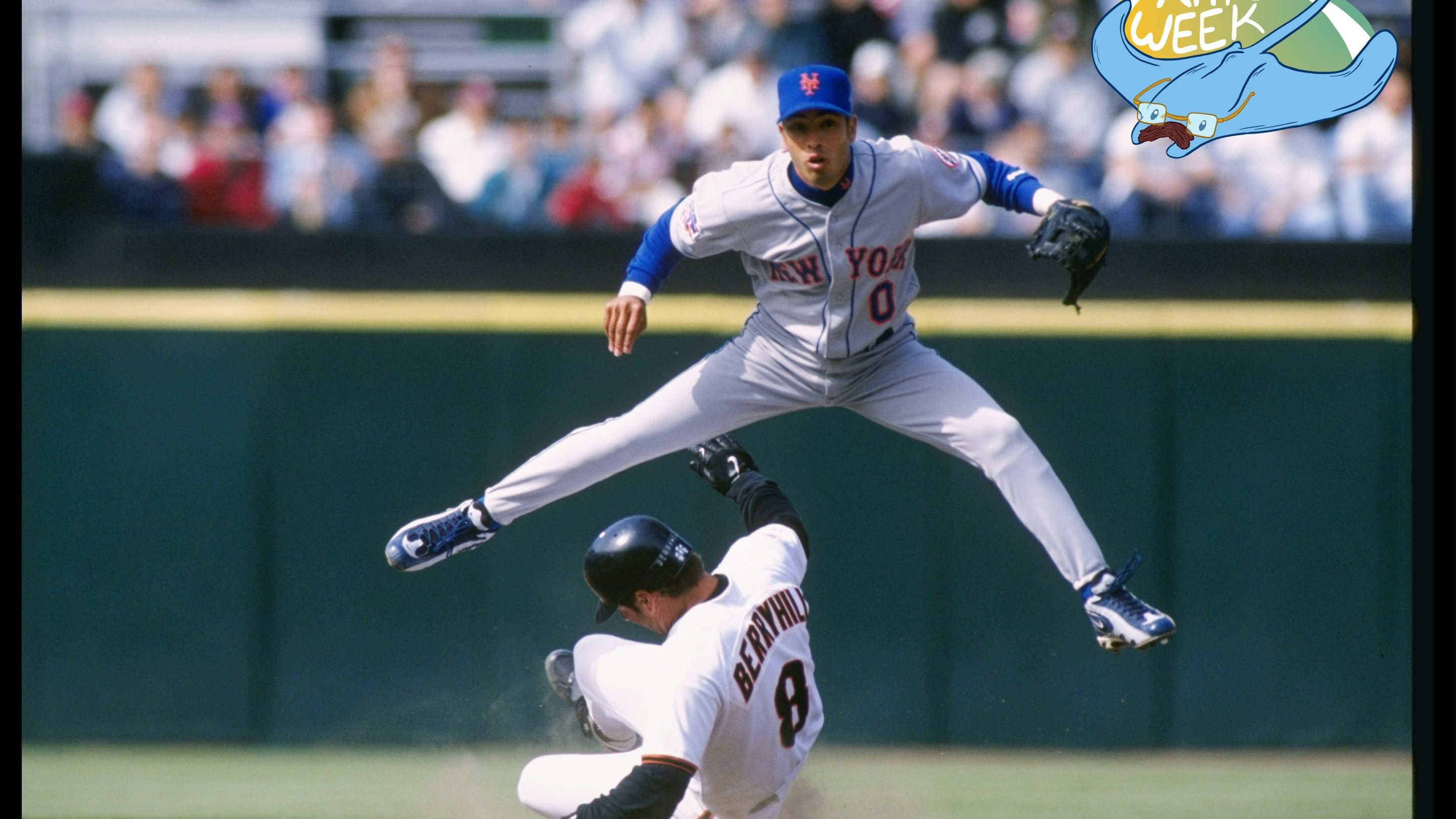 Mets shortstop Rey Ordonez leaps over a sliding Damon Berryhill in a 1997 MLB game.