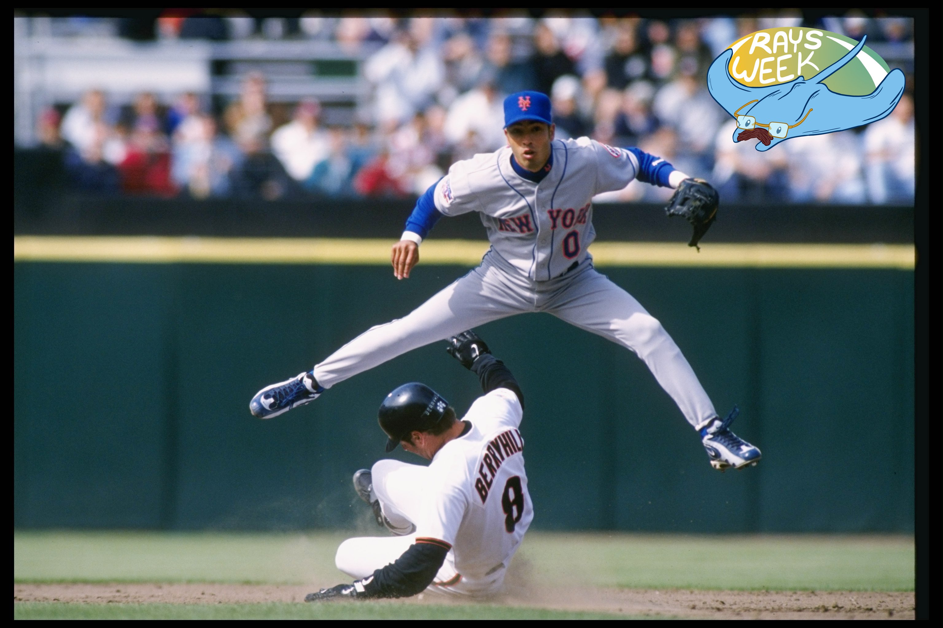 Mets shortstop Rey Ordonez leaps over a sliding Damon Berryhill in a 1997 MLB game.