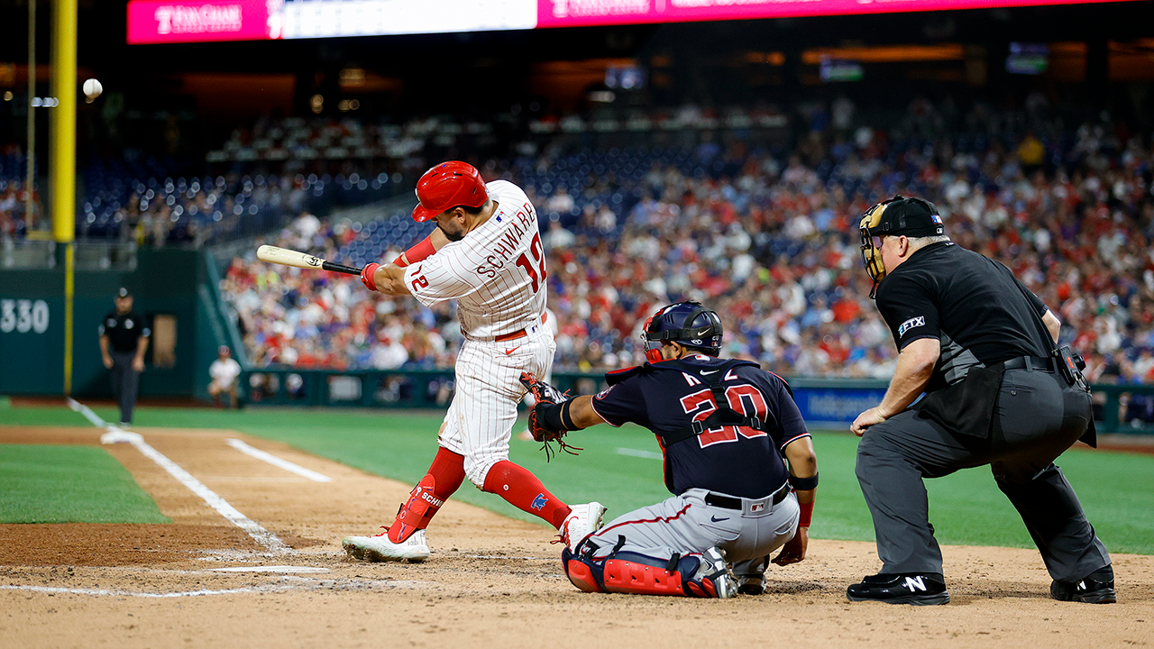 PHILADELPHIA, PENNSYLVANIA - JULY 06: Kyle Schwarber #12 of the Philadelphia Phillies hits a solo home run in the sixth inning against the Washington Nationals at Citizens Bank Park on July 06, 2022 in Philadelphia, Pennsylvania. (Photo by Tim Nwachukwu/Getty Images)