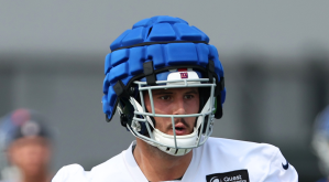 A New York Giant wearing a giant silly shell on his helmet