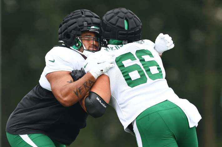 Some New York Jets, wearing the big dumb helmet helmet