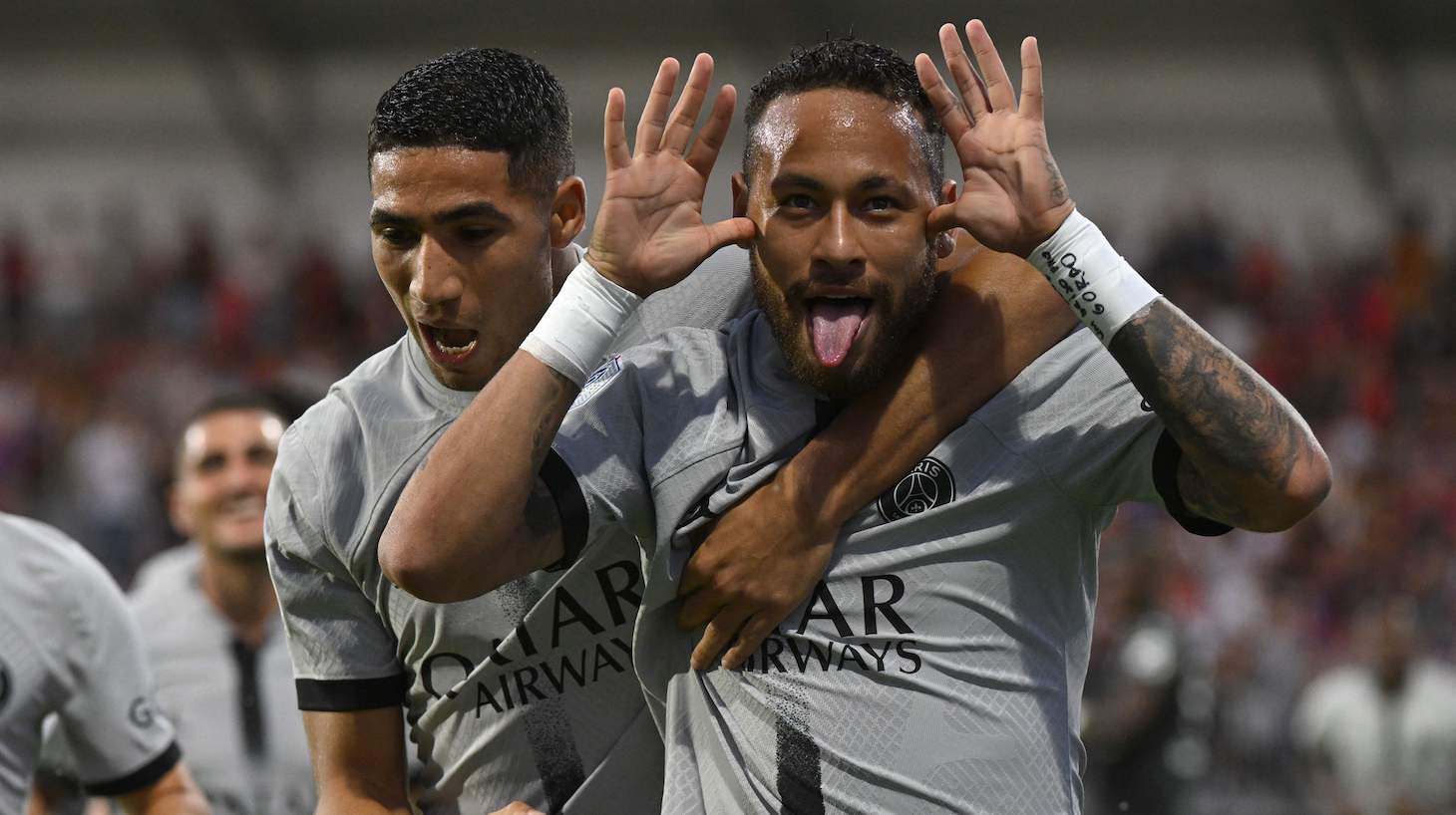 Paris Saint-Germain's Brazilian forward Neymar (R) celebrates with Paris Saint-Germain's Moroccan defender Achraf Hakimi after scoring a goal during the French L1 football match between Clermont Foot 63 and Paris Saint-Germain at Stade Gabriel Montpied in Clermont-Ferrand, central France on August 6, 2022.