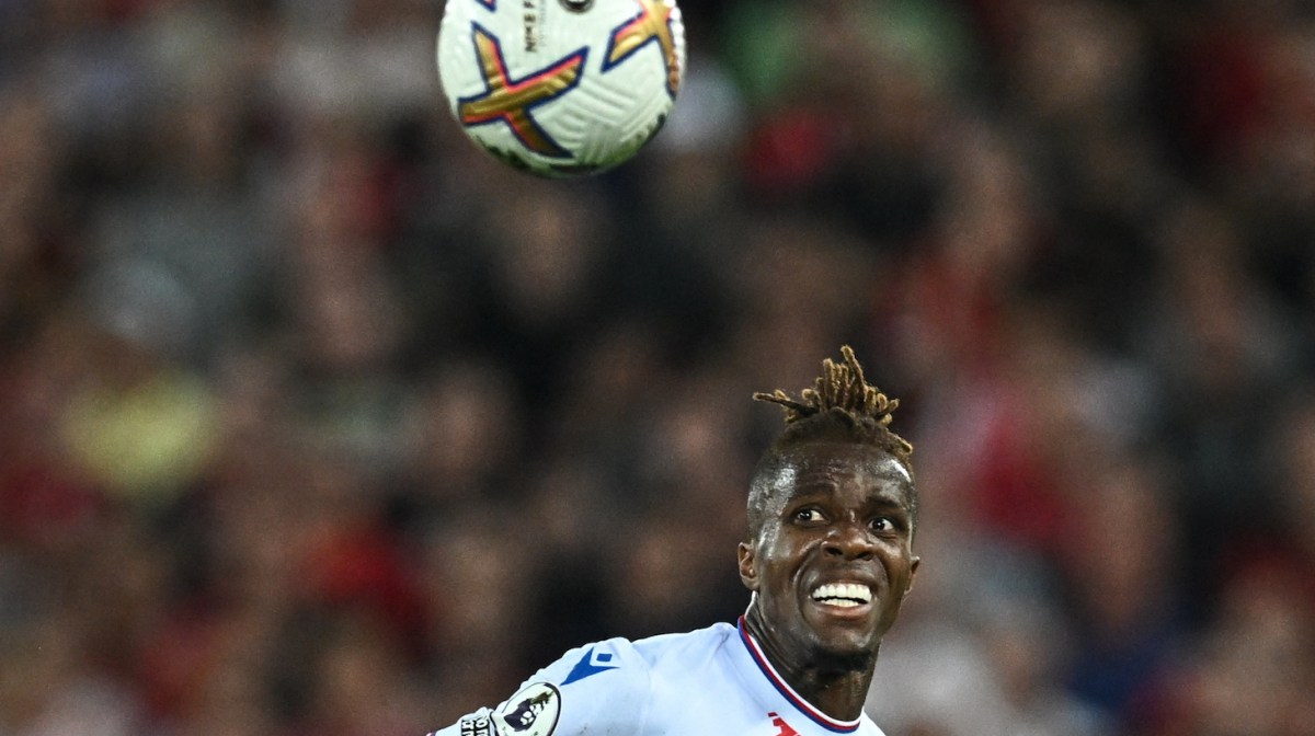 Crystal Palace's Ivorian striker Wilfried Zaha eyes the ball during the English Premier League football match between Liverpool and Crystal Palace at Anfield stadium, in Liverpool, north west England on August 15, 2022.