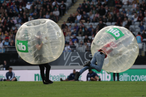 Some New Zealanders play rugby inside of giant inflatable bubbles